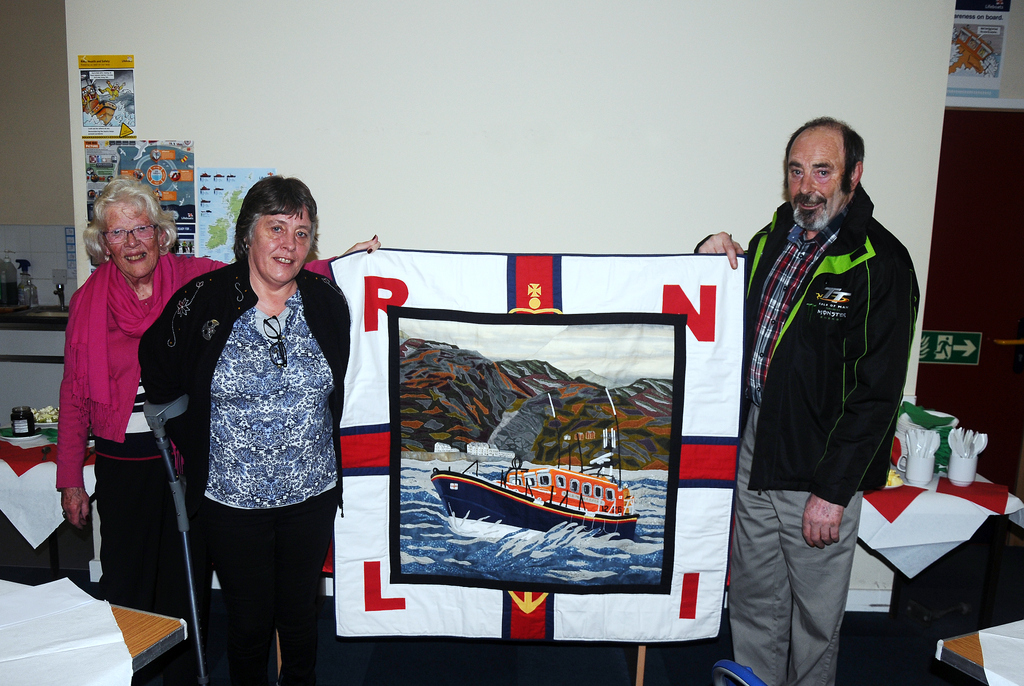 Fundraising Chair Wendy Ponsford receives quilt from Sallie and Derek Haywood