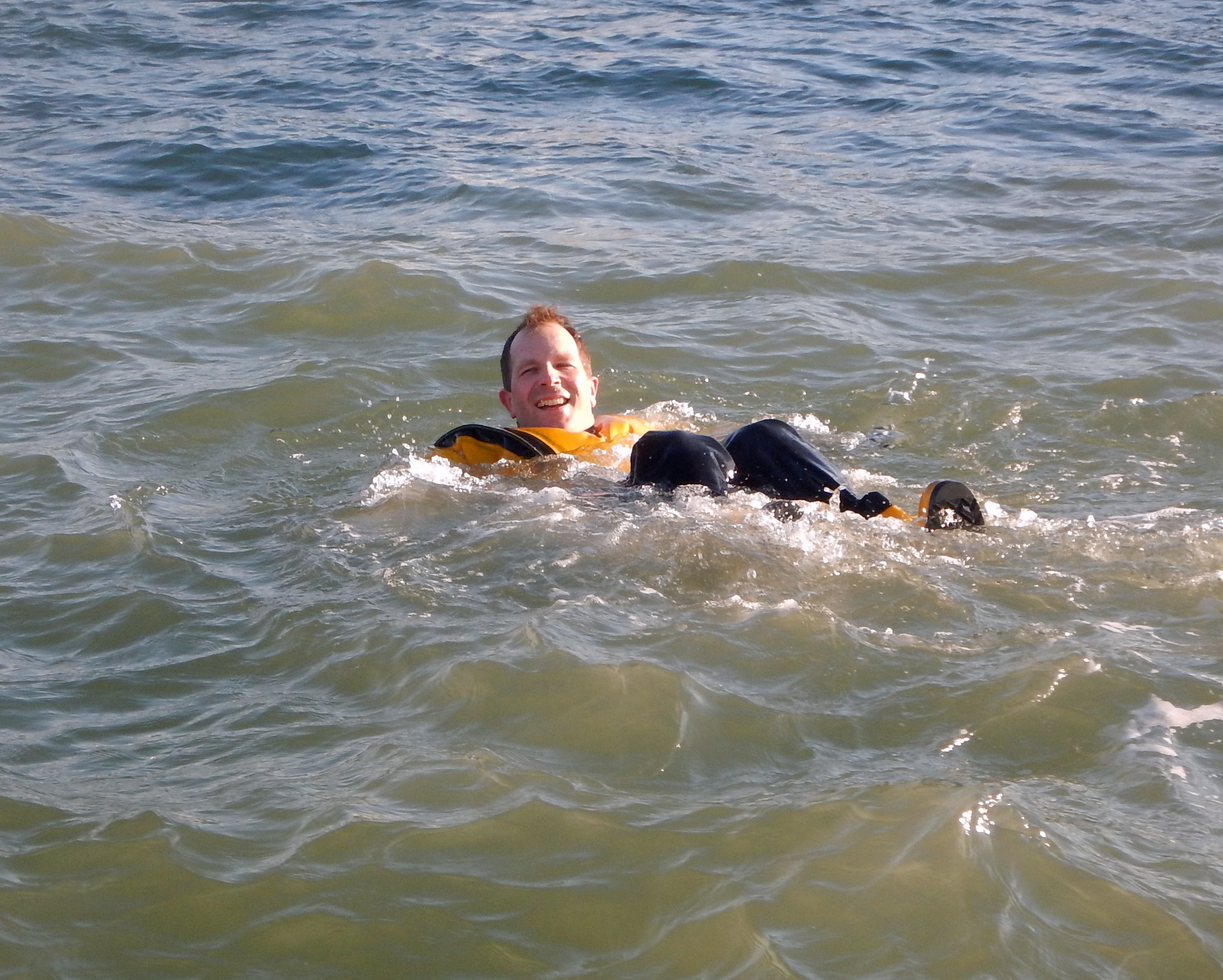 Cowes lifeboat member Dr Will King struggles to keep up with the other swimmers, in his dry suit.