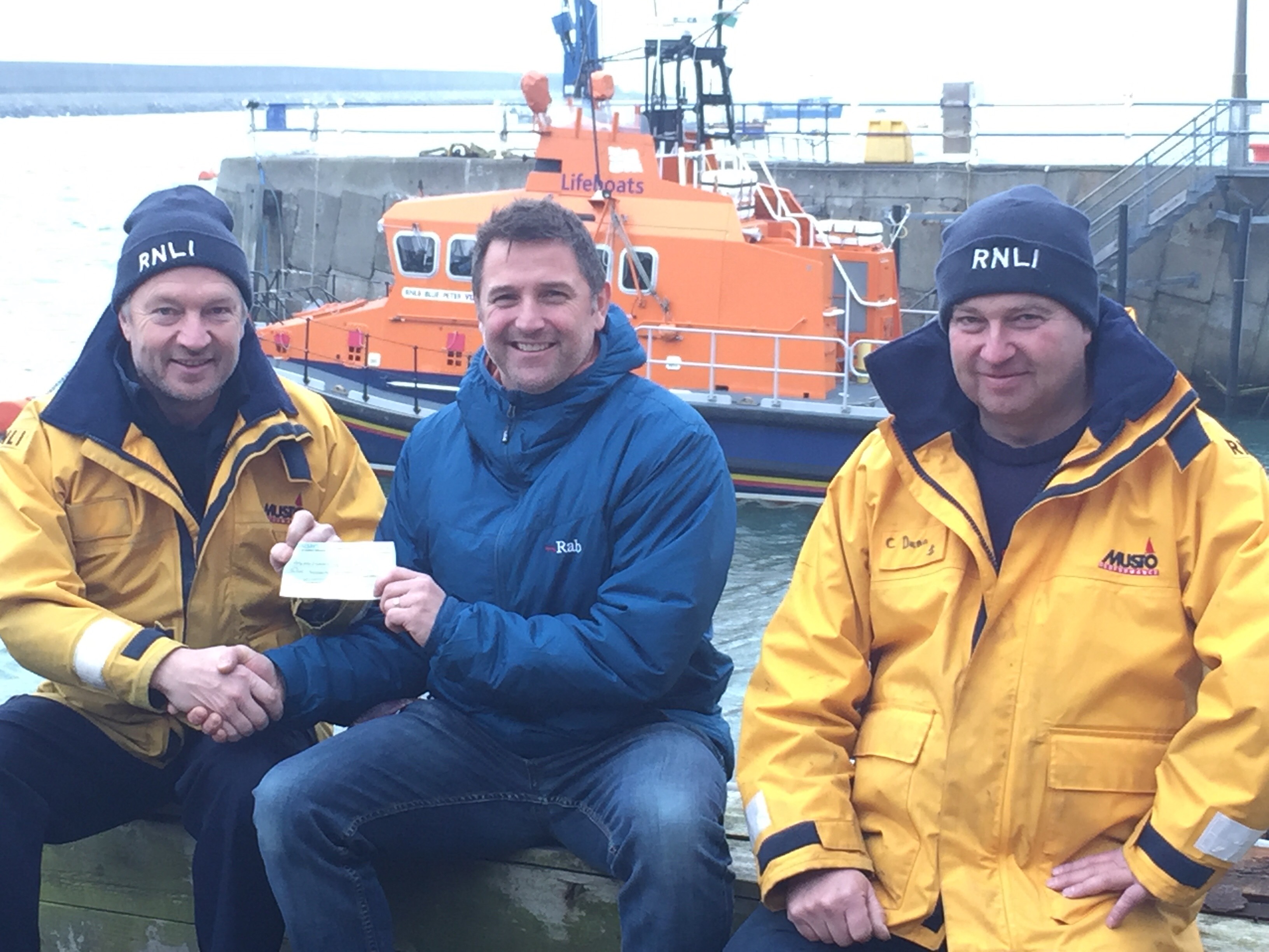 from left to right: Fishguard RNLI Coxswain Paul Butler, Mark Bean and Fishguard RNLI Assistant Mechanic Colin Dunn