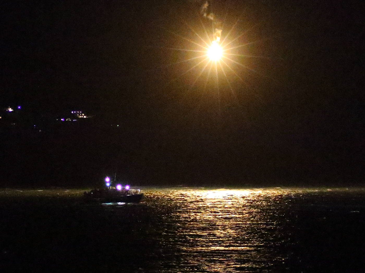 Douglas lifeboat Sir William Hillary searches under the light from a parachute flare