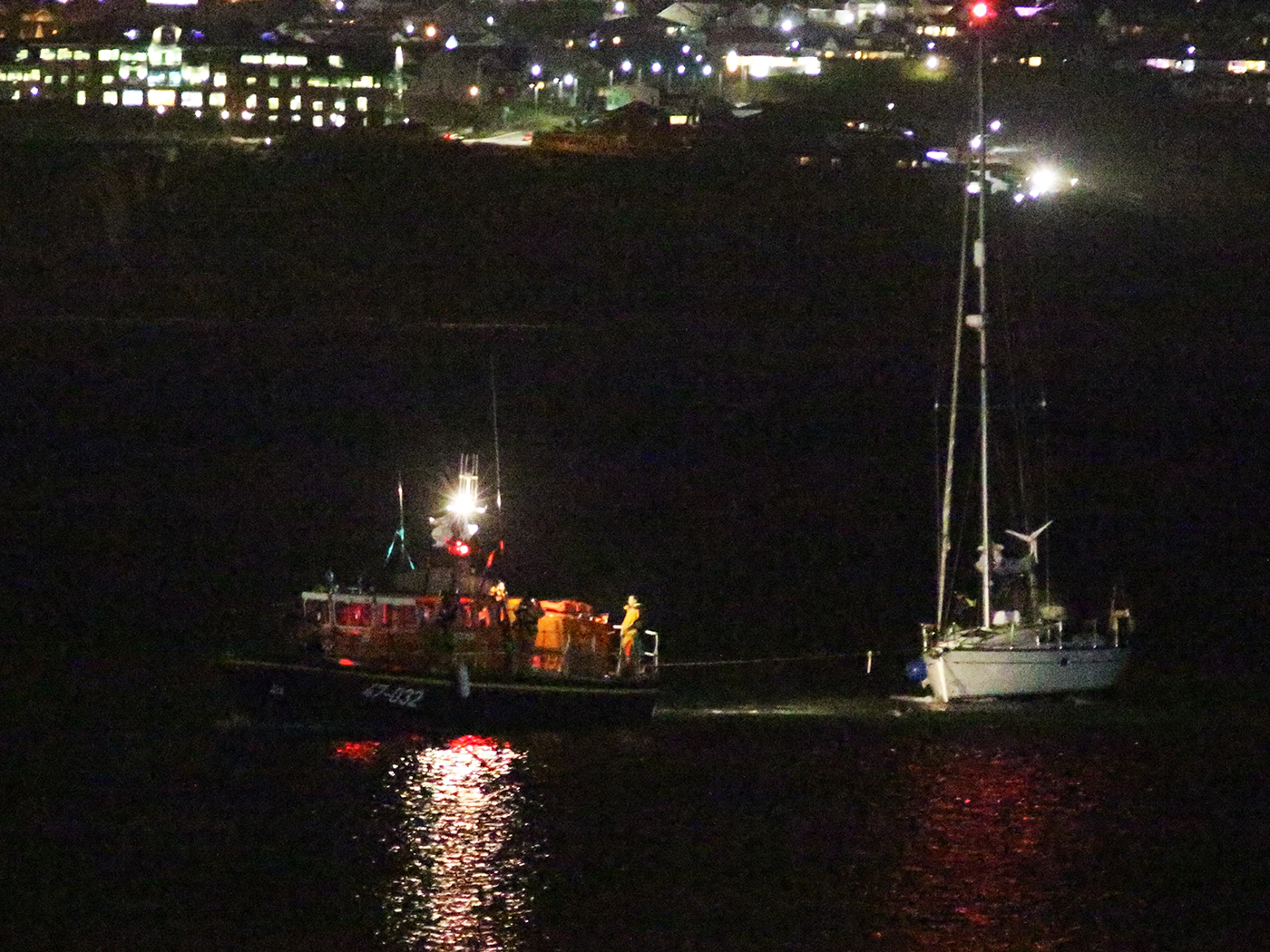 Douglas RNLI lifeboat returning to harbour with casualty vessel.