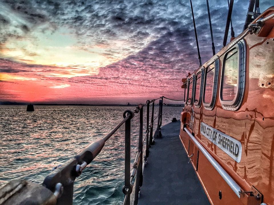 Poole all-weather lifeboat heading into the sunset
