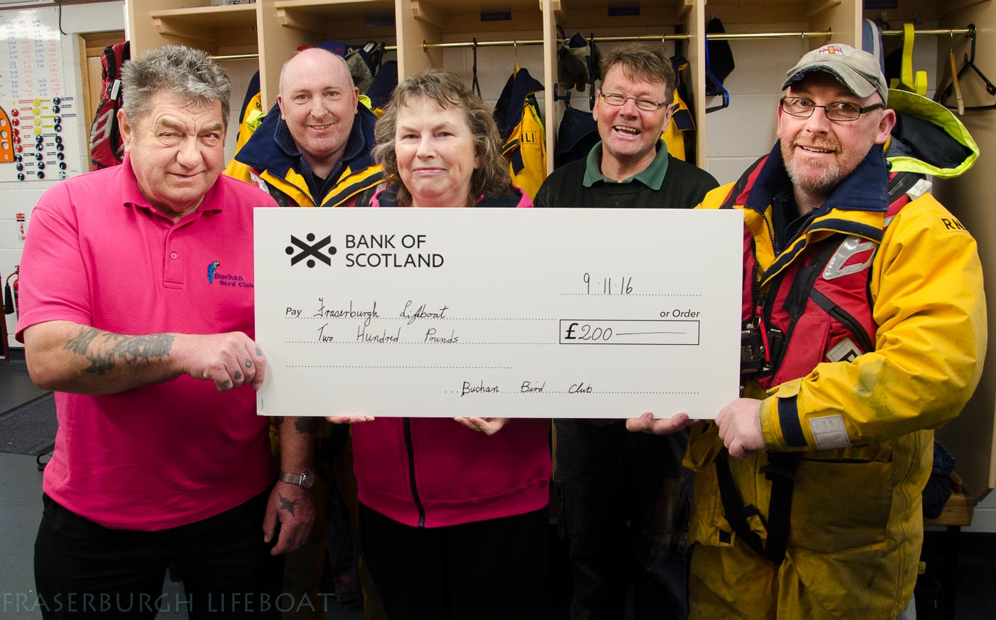 Isobel and Duggie Beedie, and Norman Robertson from the Buchan Bird Club presented Fraserburgh Lifeboat Coxswain Vic Sutherland and Lifeboat Operations Manager Hamish Partridge with a cheque for £200 inside the crew changing room at Fraserburgh Lifeboat Station.