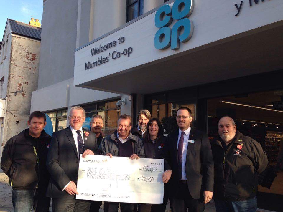 Crew receive cheque from store managers
