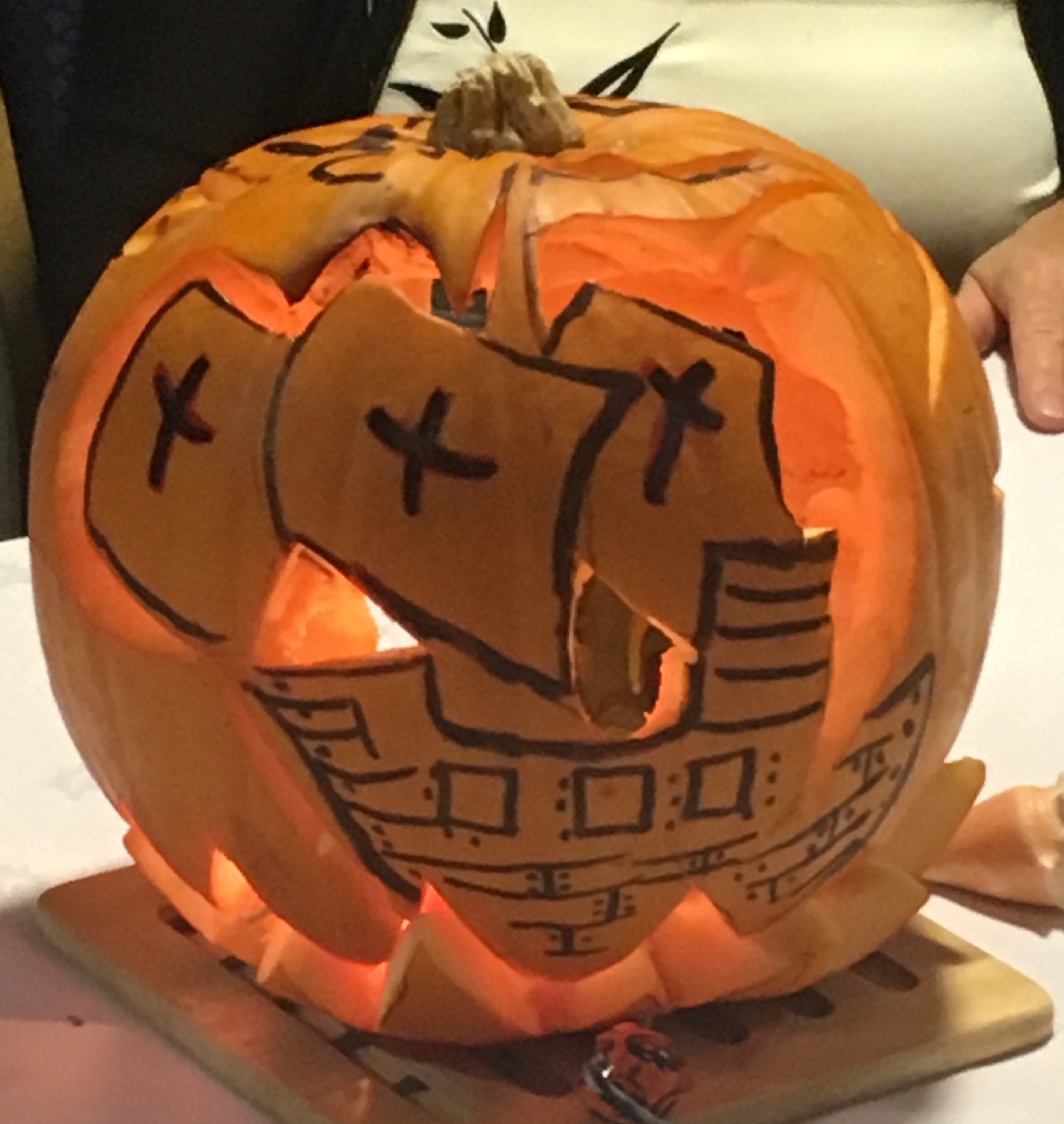 Large pumpkin, with sailing ship carved on the front.