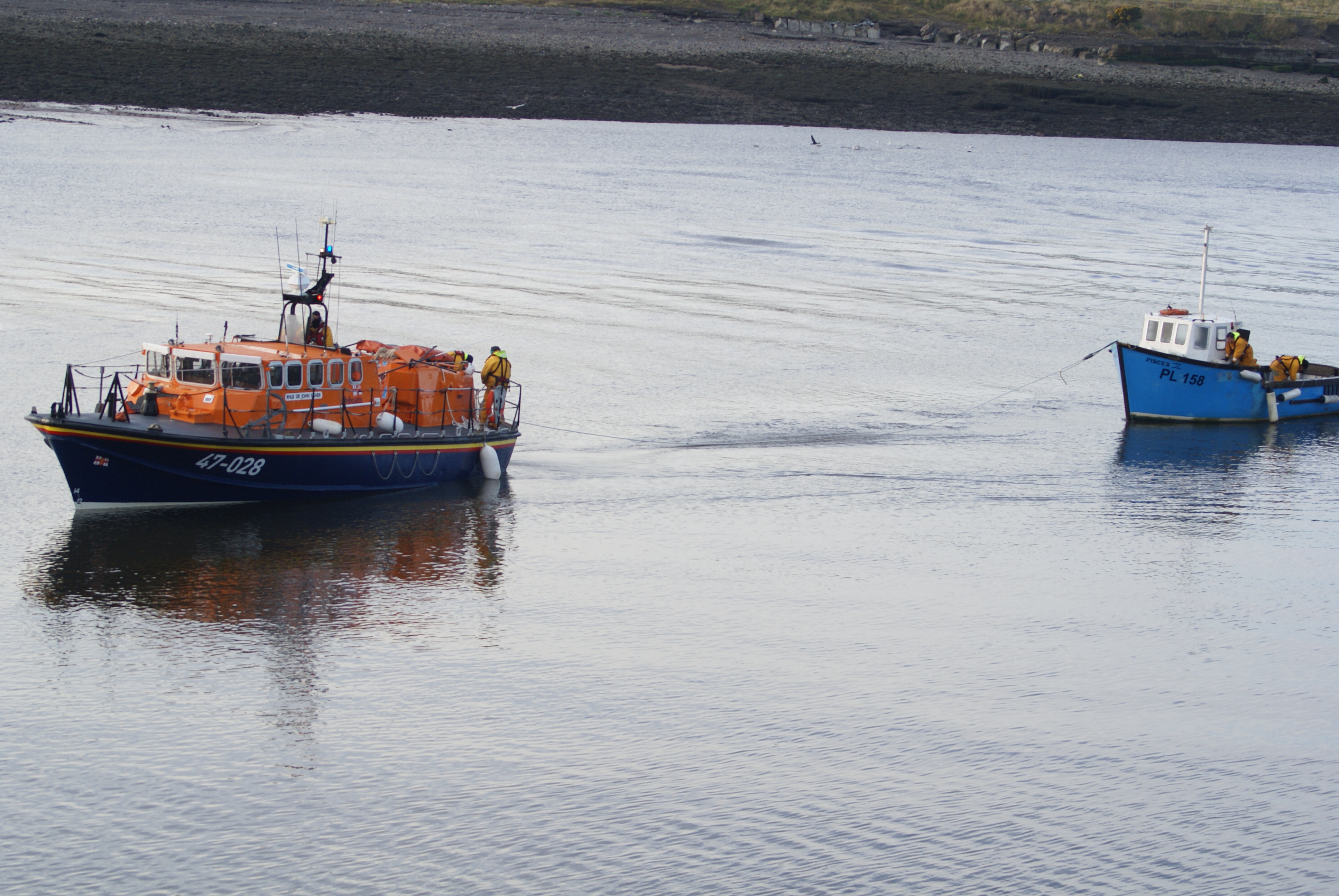 Fishing boat Pisces being towed into Workington Harbour