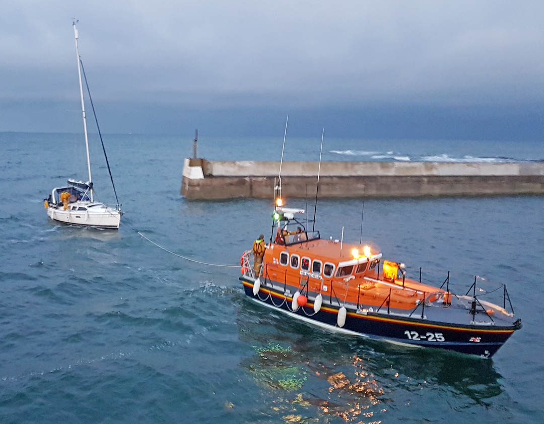 The yacht under tow by RNLI Seahouses