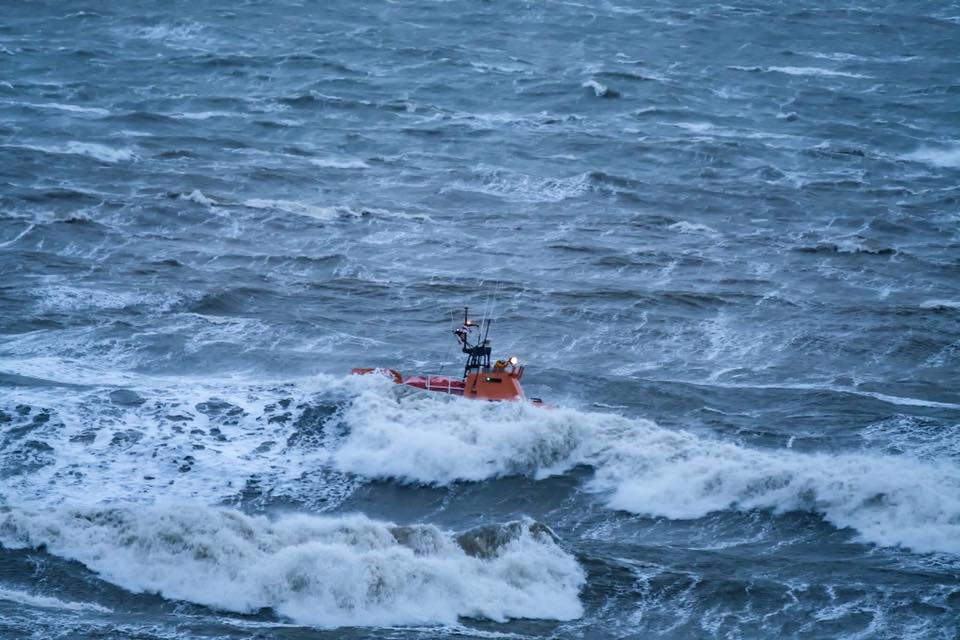 Dover RNLI lifeboat is barely visible among rough seas during the search