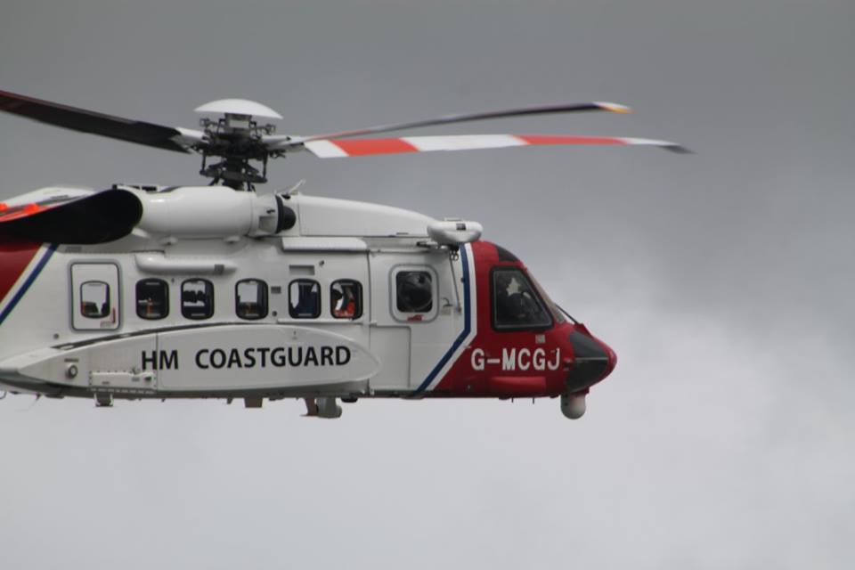 The red & white Coastguard helicopter in action close up.