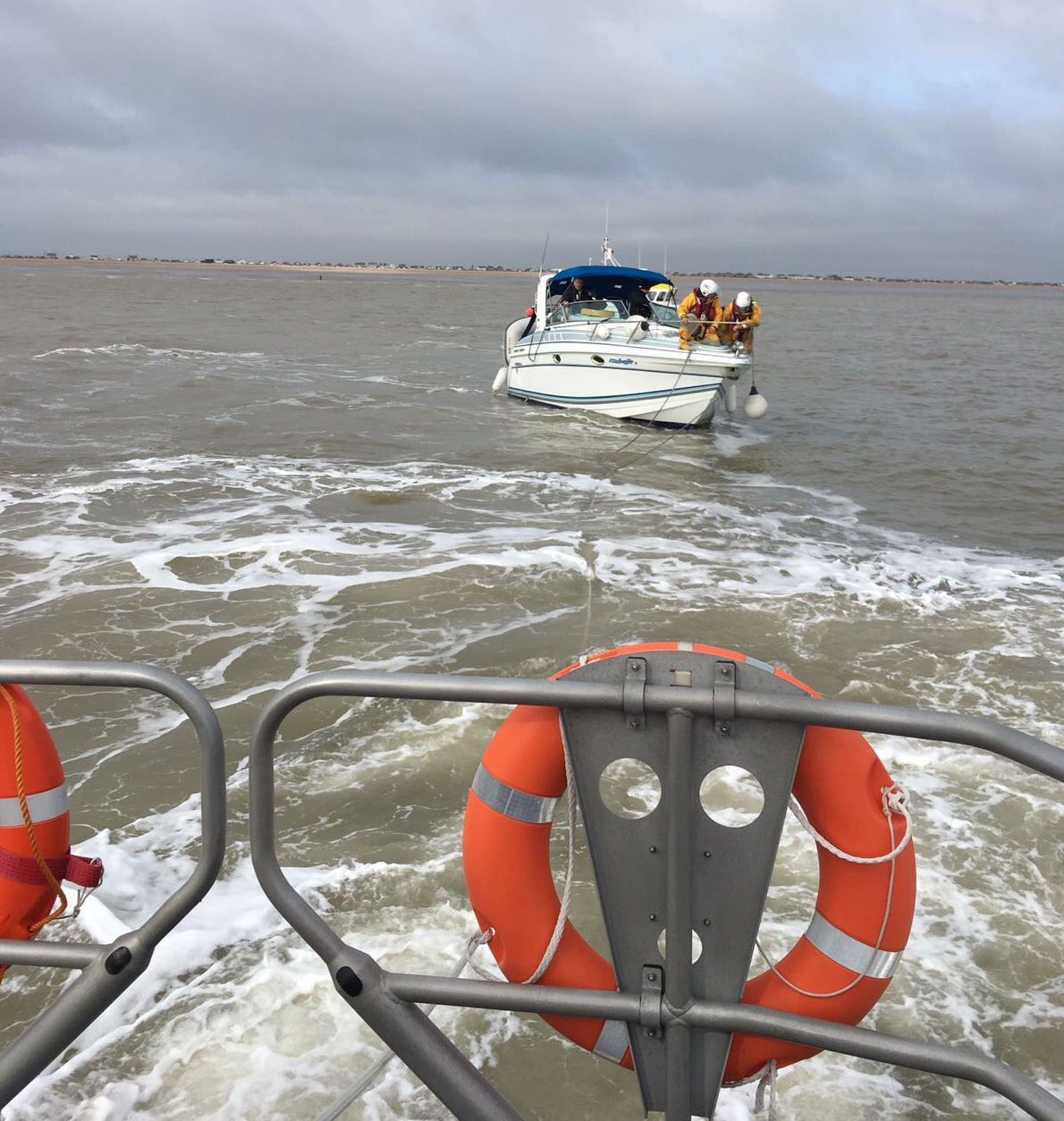 Two volunteer crew members establishing tow from Dungeness RNLI lifeboat