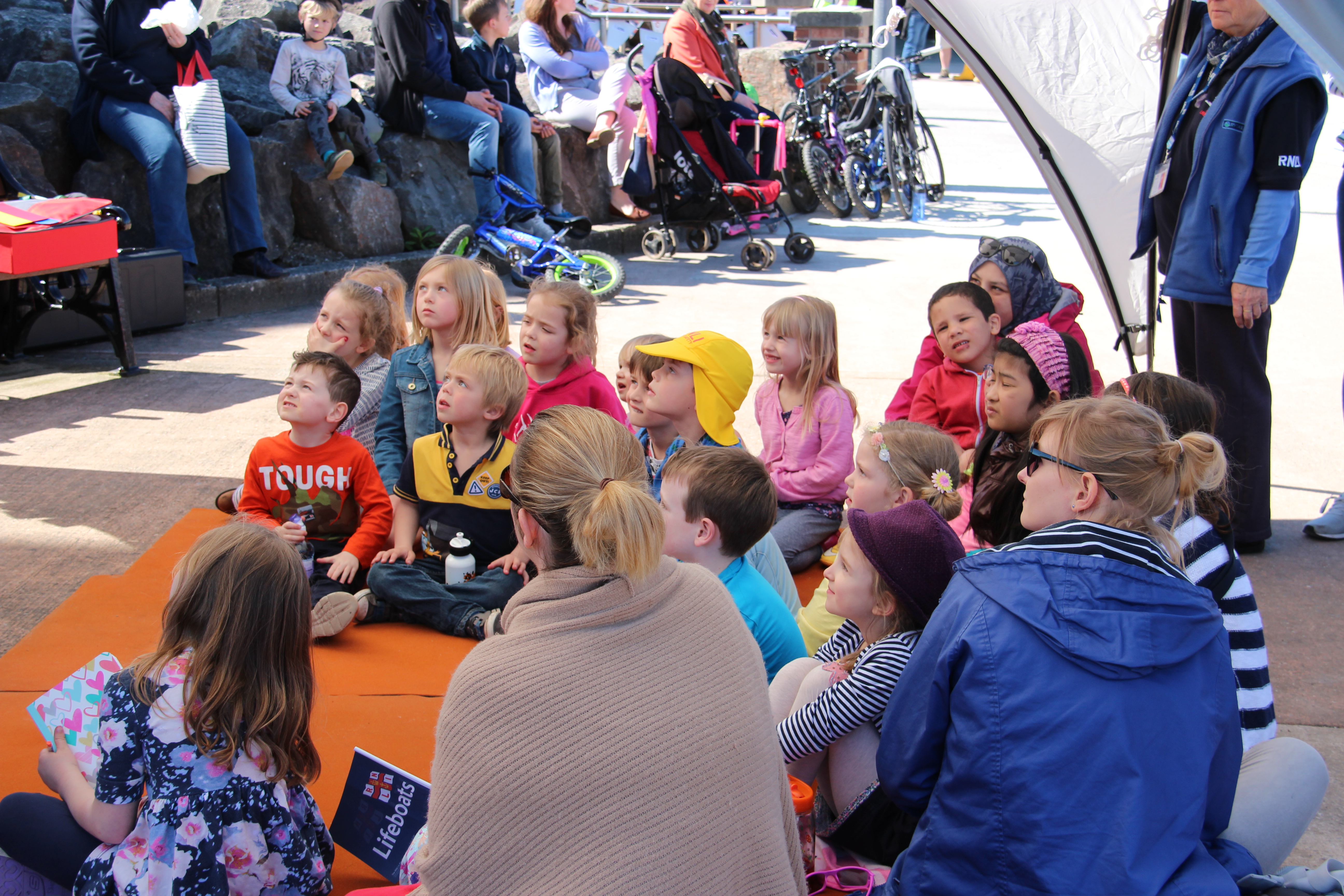 Children &amp; parents sat watching the Beach Buddies puppet show