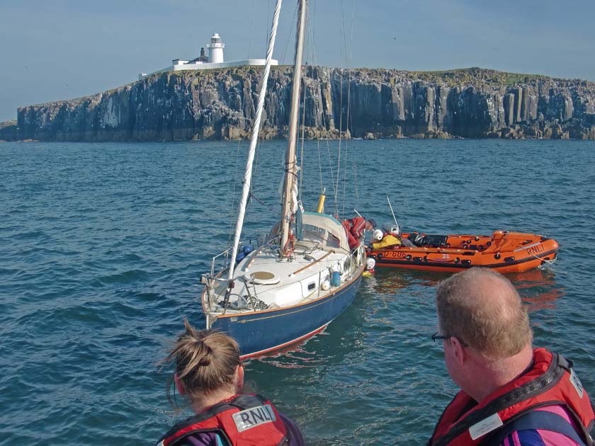 RNLI Crew trying to free rope from yacht propeller