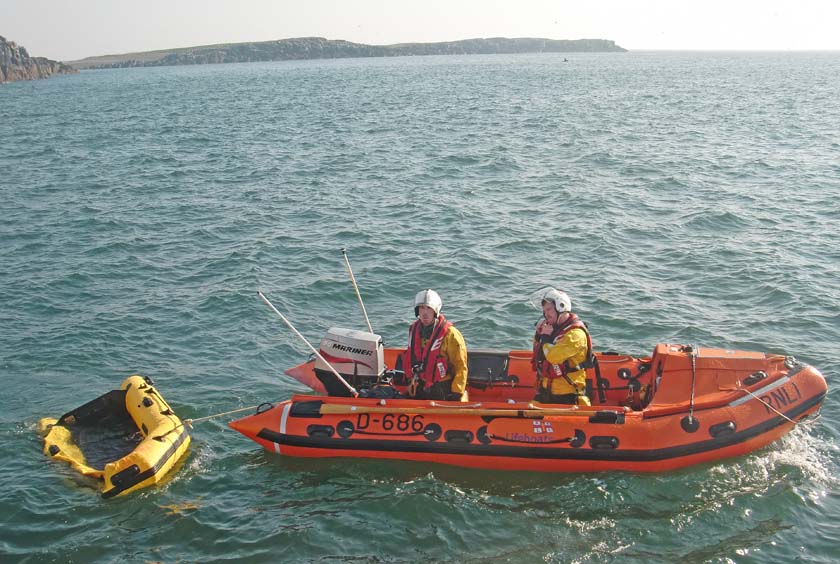 Inshore lifeboat with damaged tender towed clear