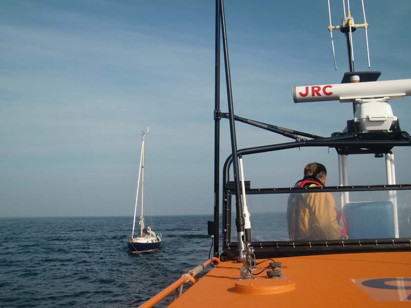 Yacht under tow, Cox Eric keeps a watchfull eye