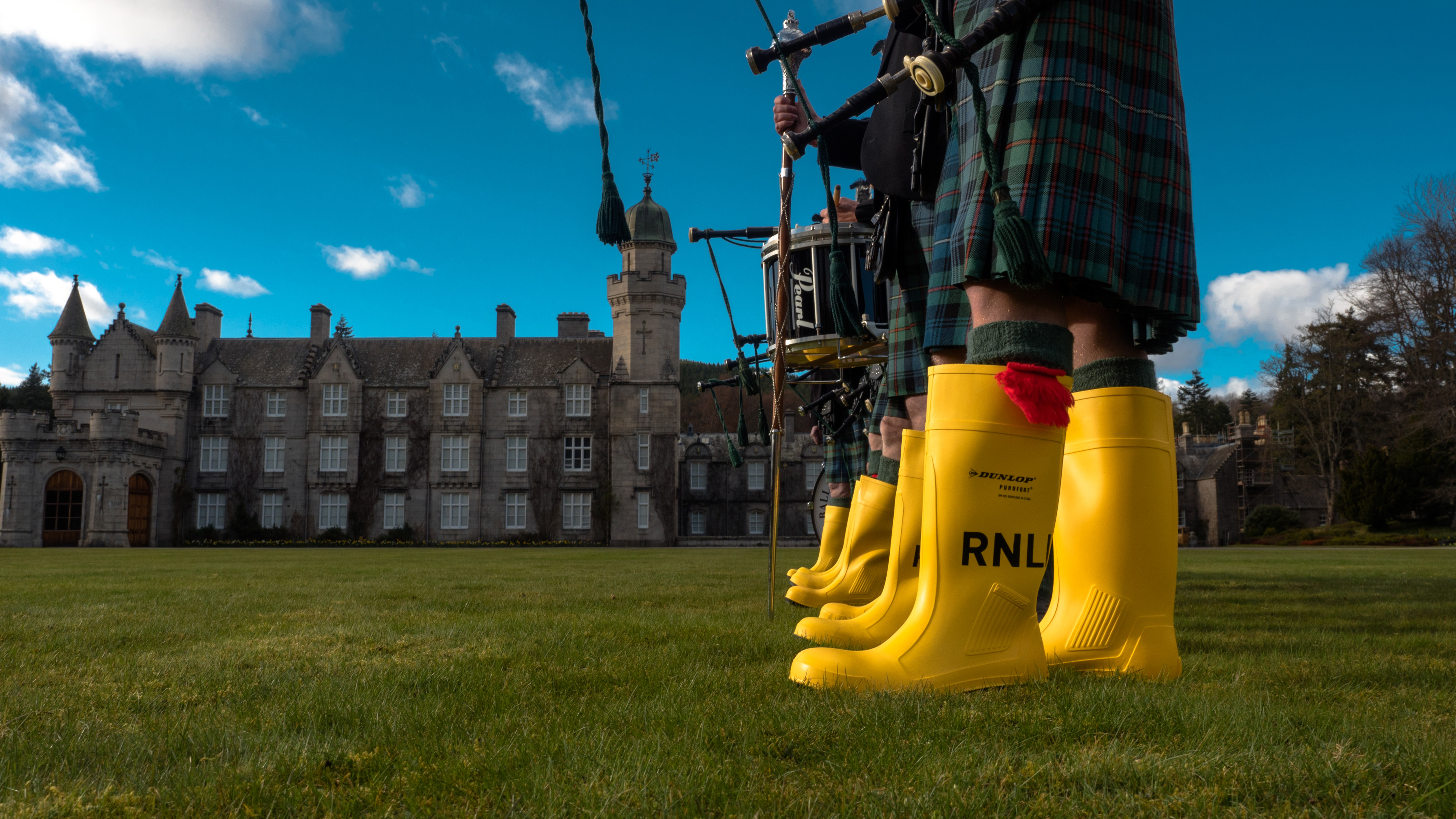 The Ballater and District Pipe Band try on the RNLI’s yellow wellies
