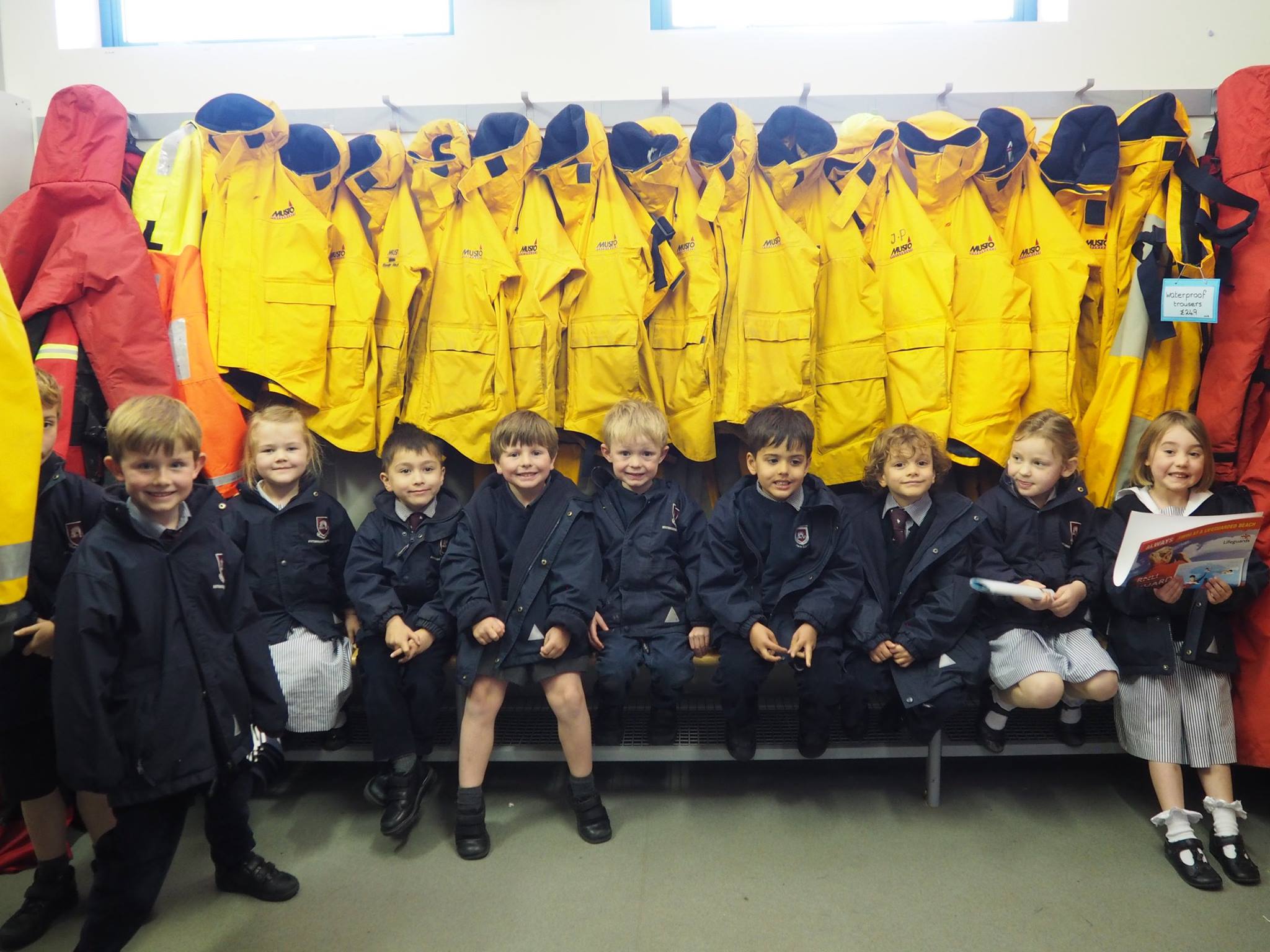School pupils in lifeboat crew kit room