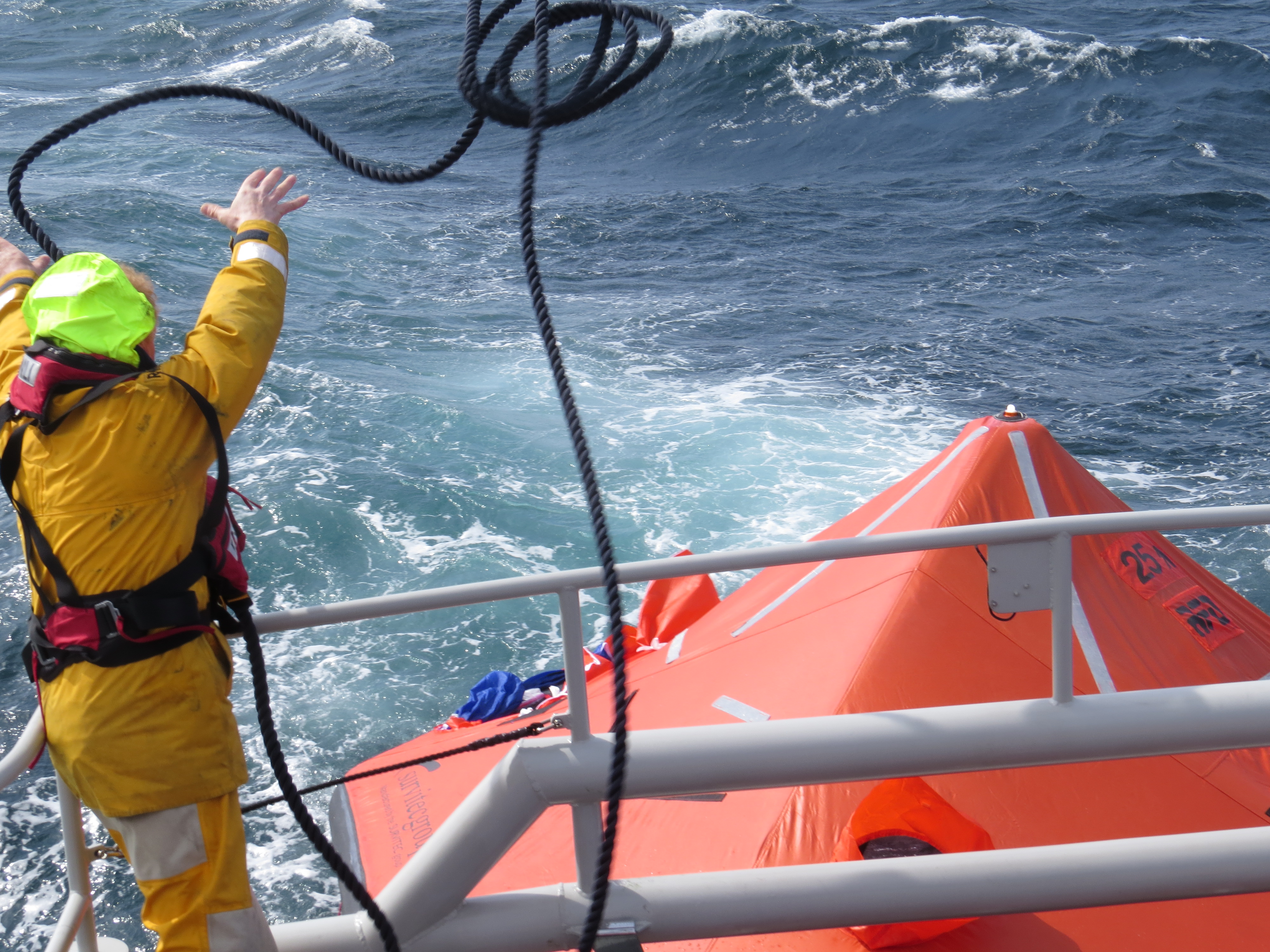 Volunteer Crew Member Kenny Budge adds another rope to liferaft