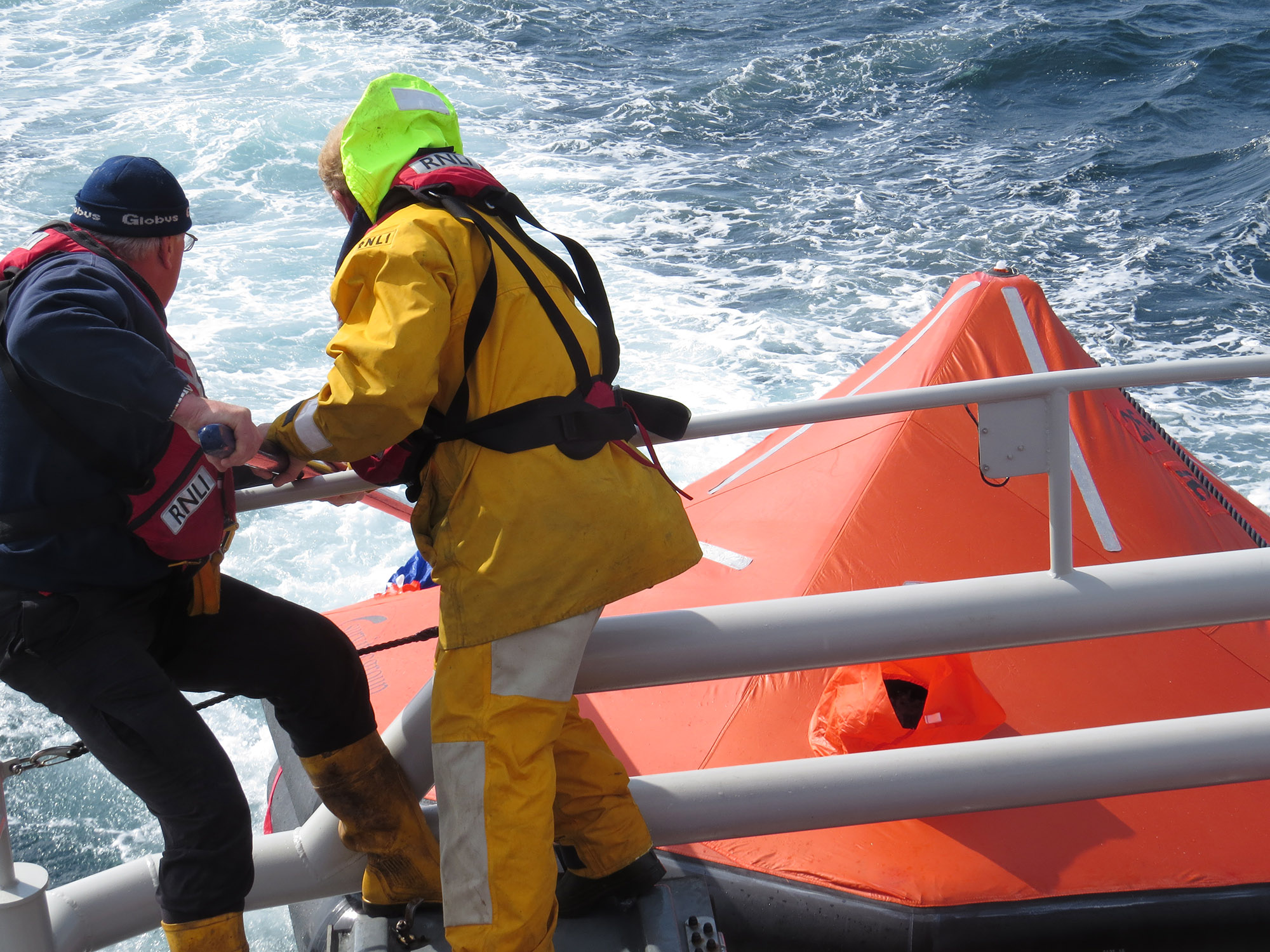 Volunteer Crew Members Kenny Budge and Colin Bates make some final adjustments to securing ropes