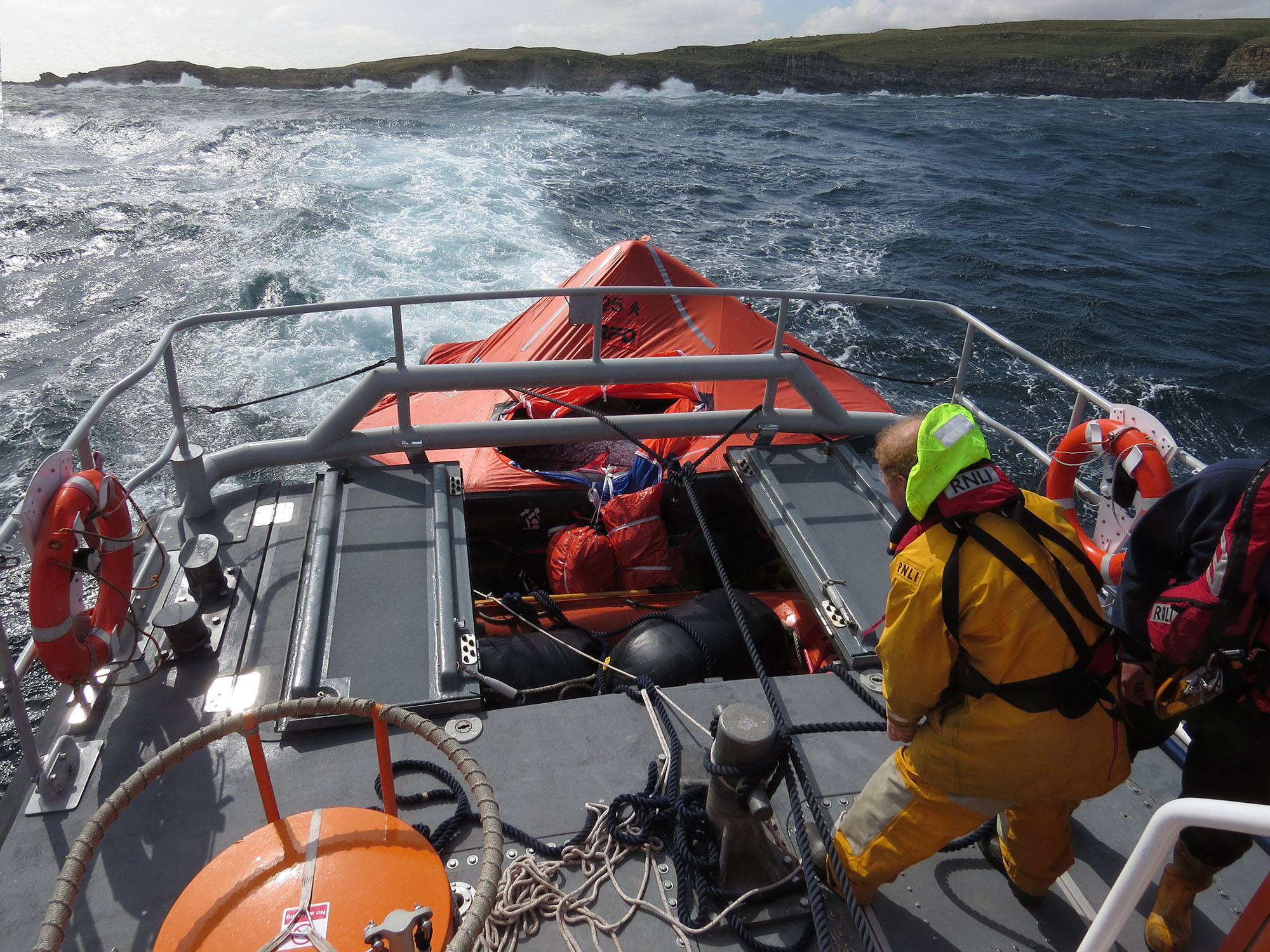 Lifeboat underway after liftraft finally secured and partially jammed into transom.