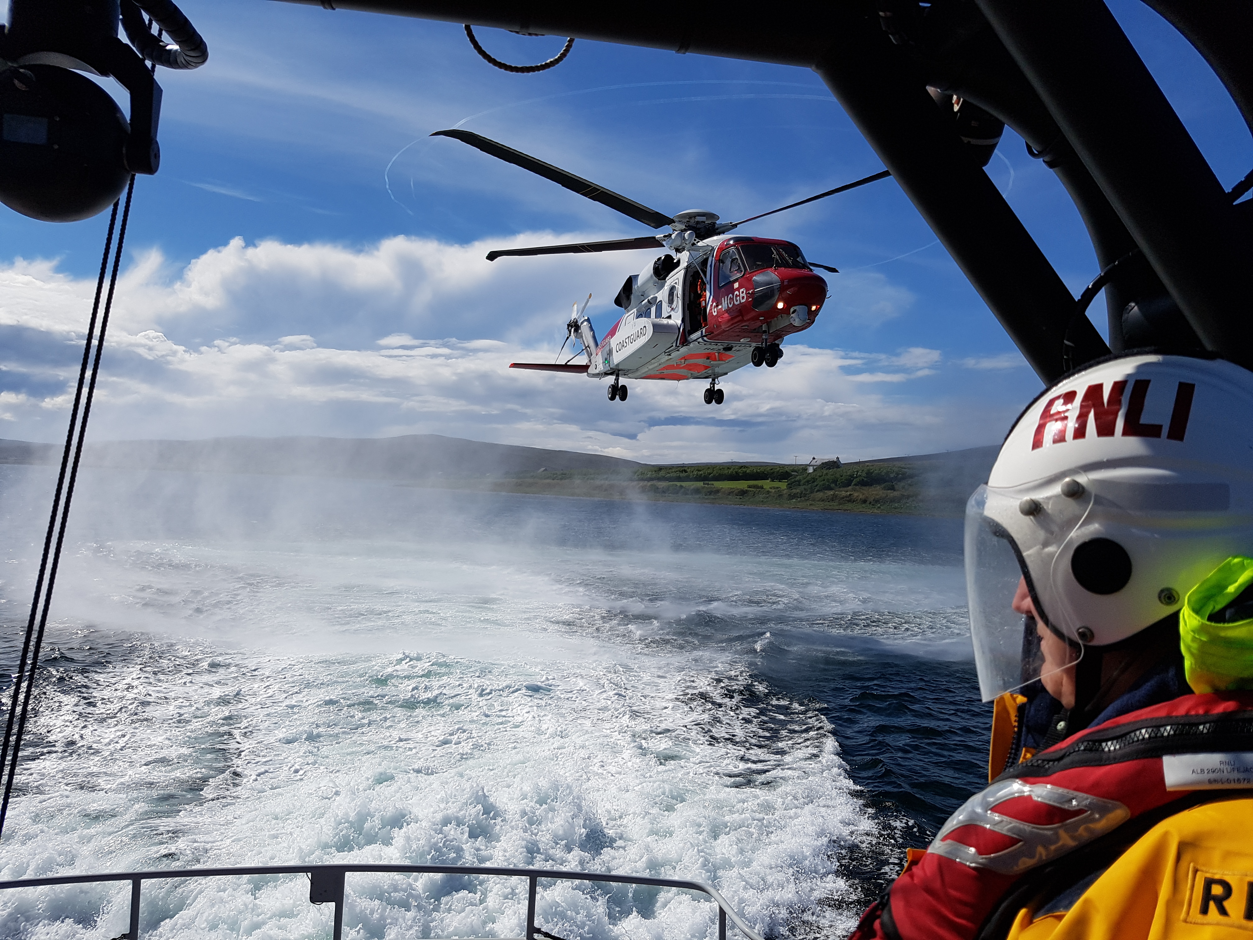UK Coastguard helicopter approaches RNLI Longhope lifeboat