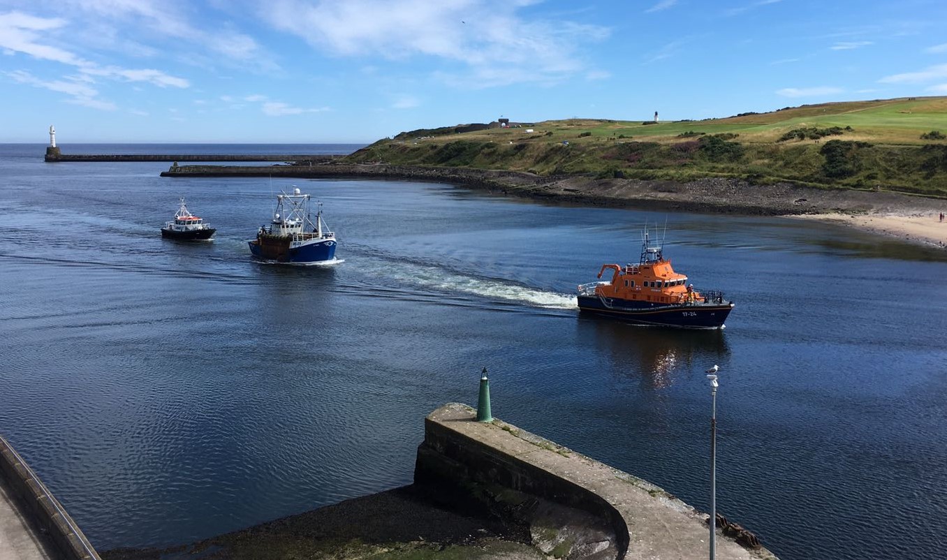 Aberdeen Lifeboat tows the fishing vessel Q-Varl into Aberdeen Harbour, with the Pilot boat behind