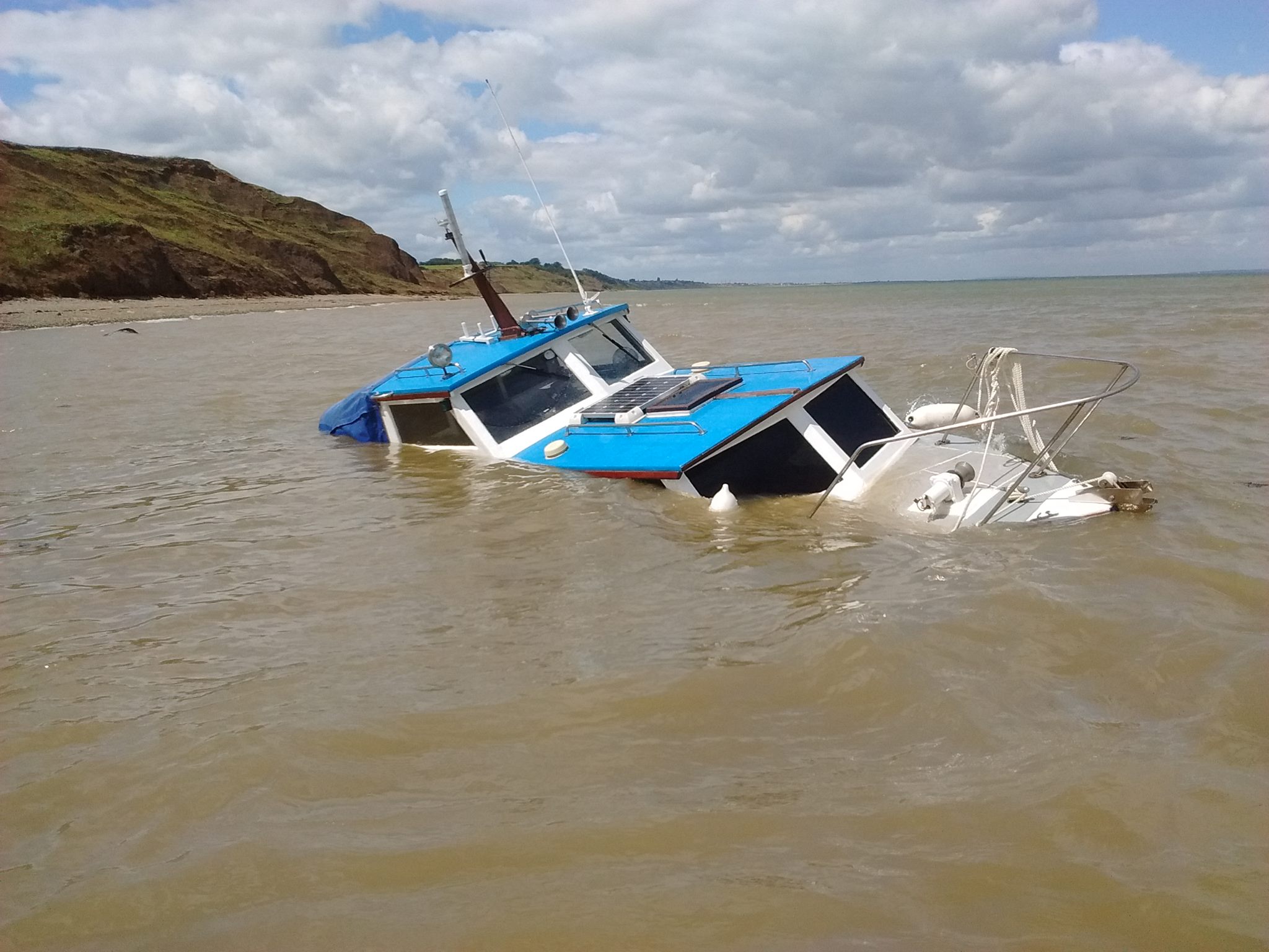 The sorry looking cabin cruiser after having been grounded at Warden Point on the Isle of Sheppey
