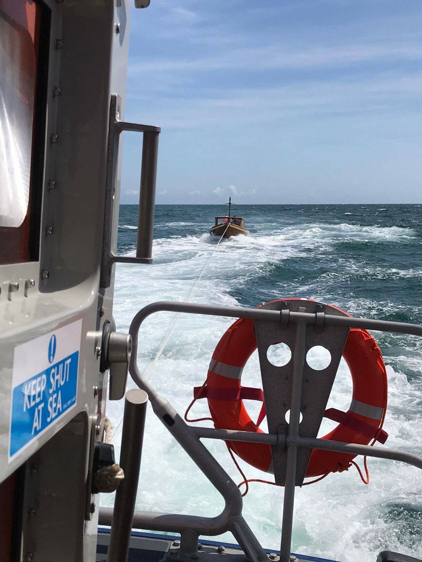 Exmouth RNLI Crew aboard Shannon class lifeboat R and J Welburn tow lone sailor to safety