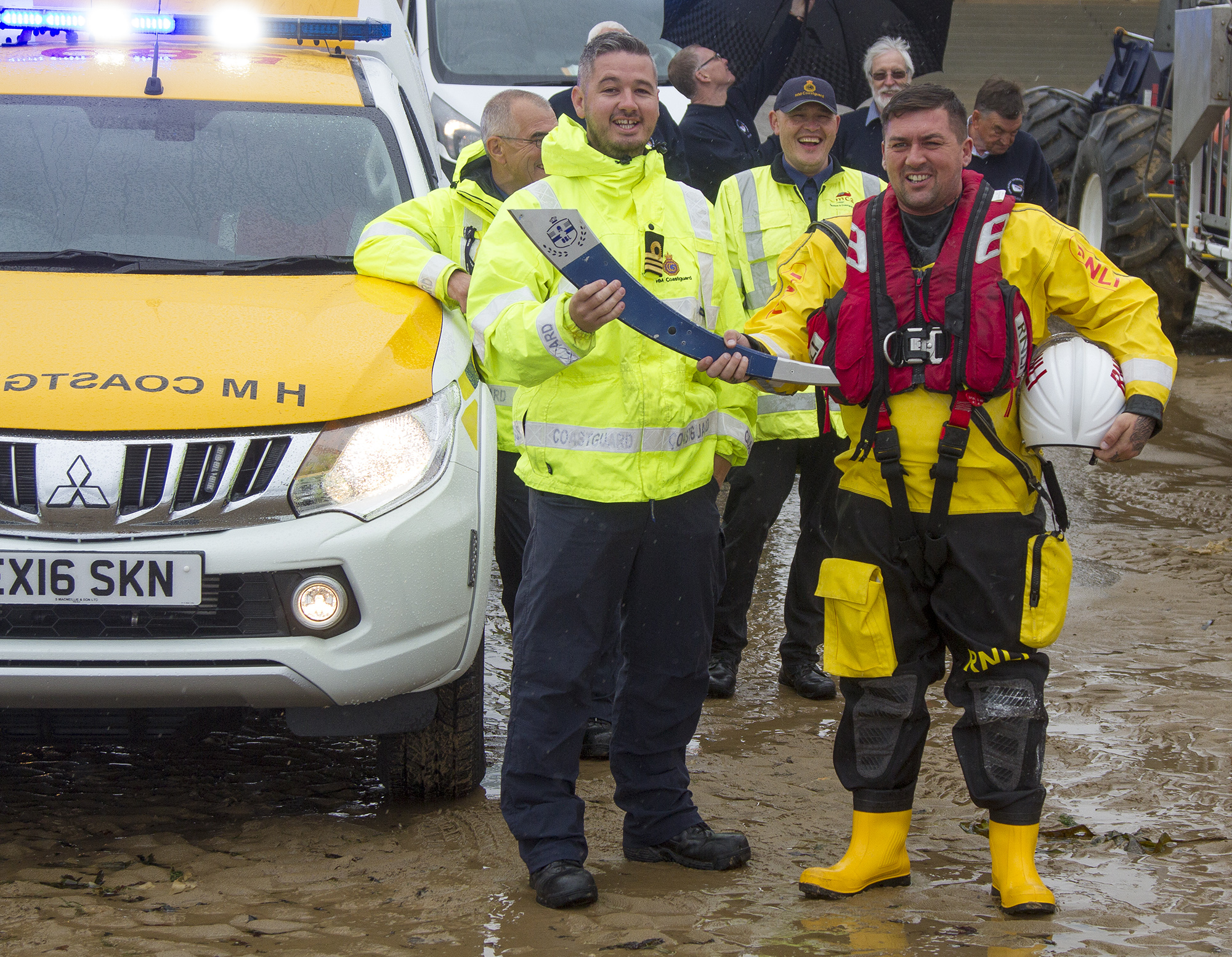 The Our Blue Light torch being handed to RNLI volunteer Paul McQuillan