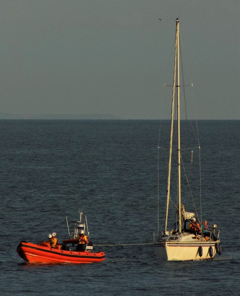 Inshore lifeboat towing casualty yacht into Ramsgate Harbour 