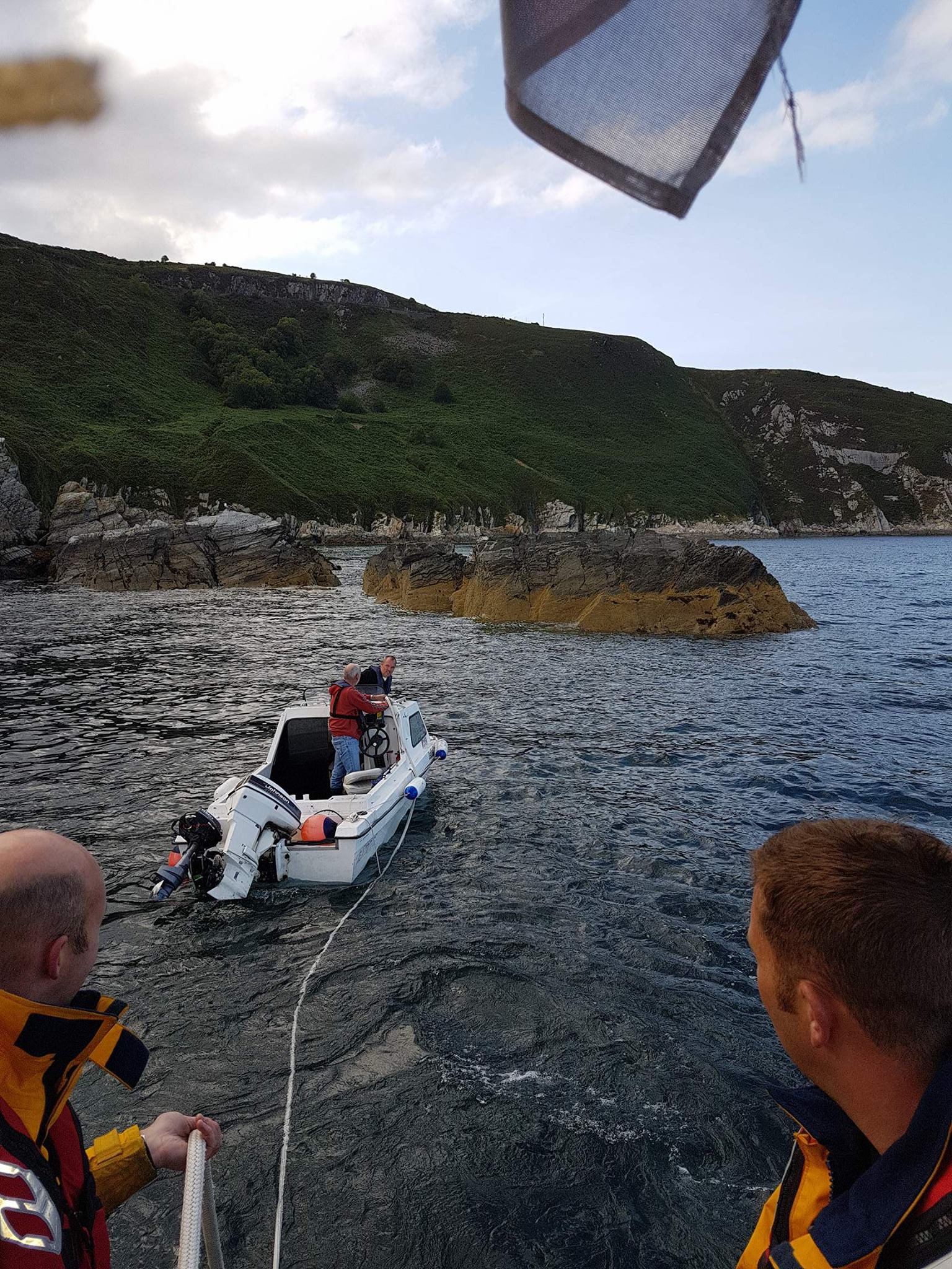 The tow rope being passed to the casualty vessel from Ramsey RNLI lifeboat.