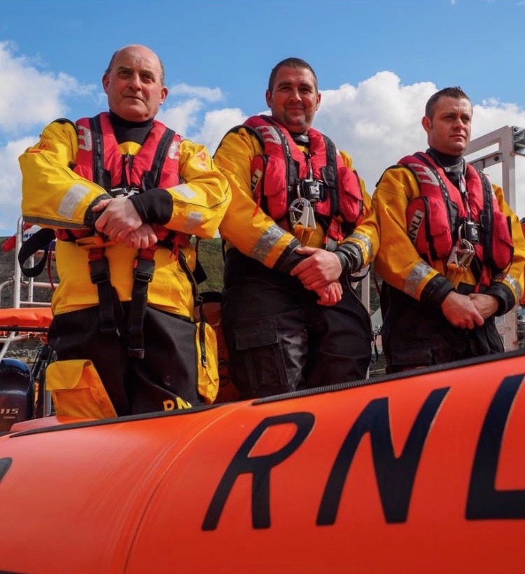Three crew members on lifeboat