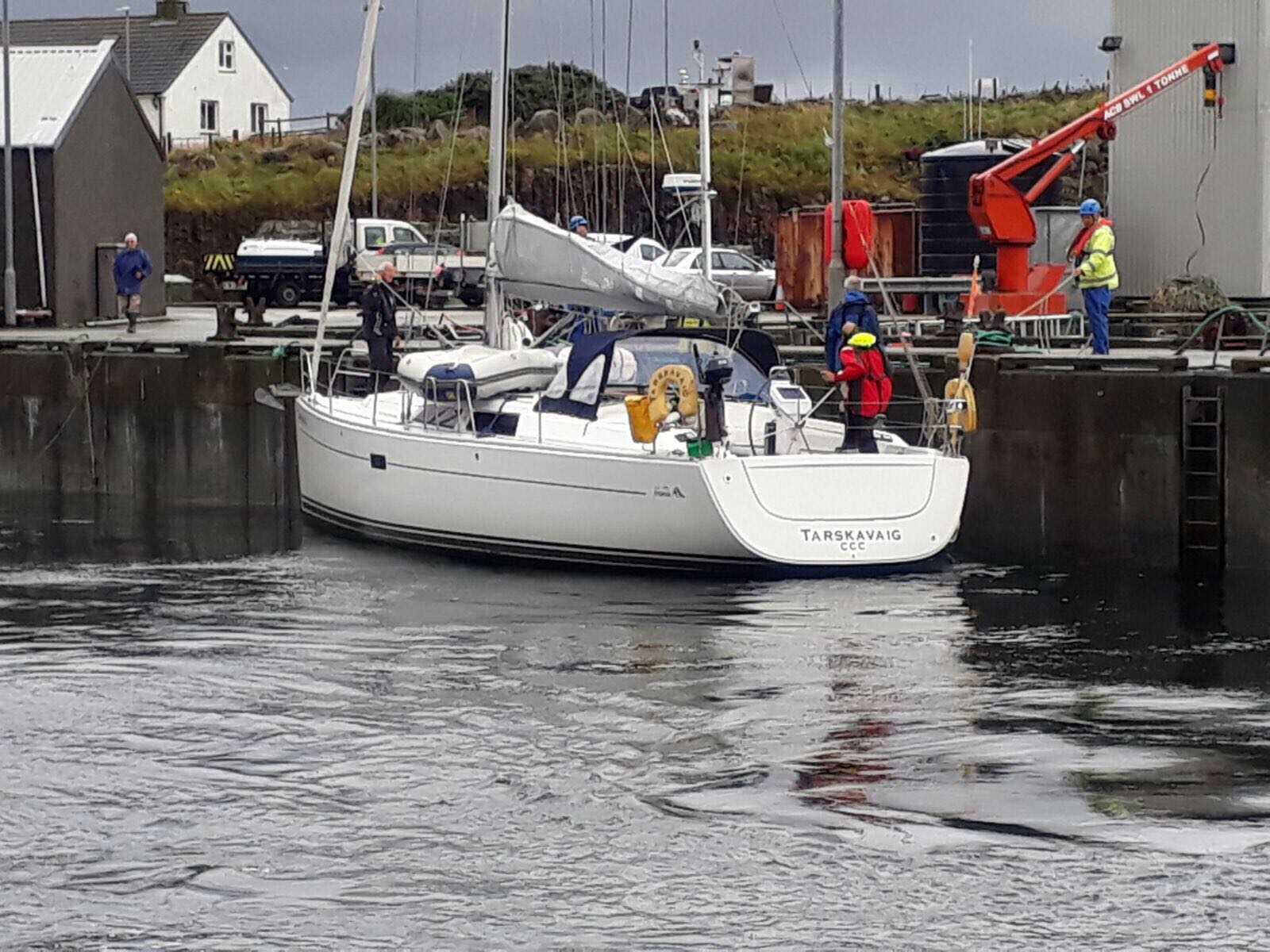 Yacht which was rescued by the Lifeboat safely alongside at Kallin Harbour, North Uist