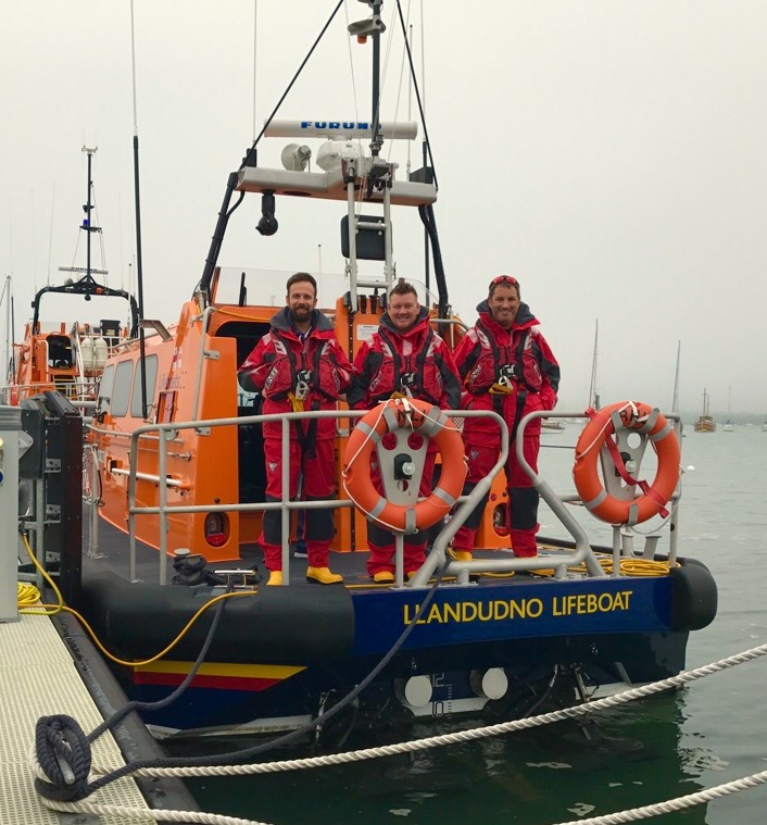 Three of the Llandudno crew aboard the lifeboat after returning to Poole following the rescues.