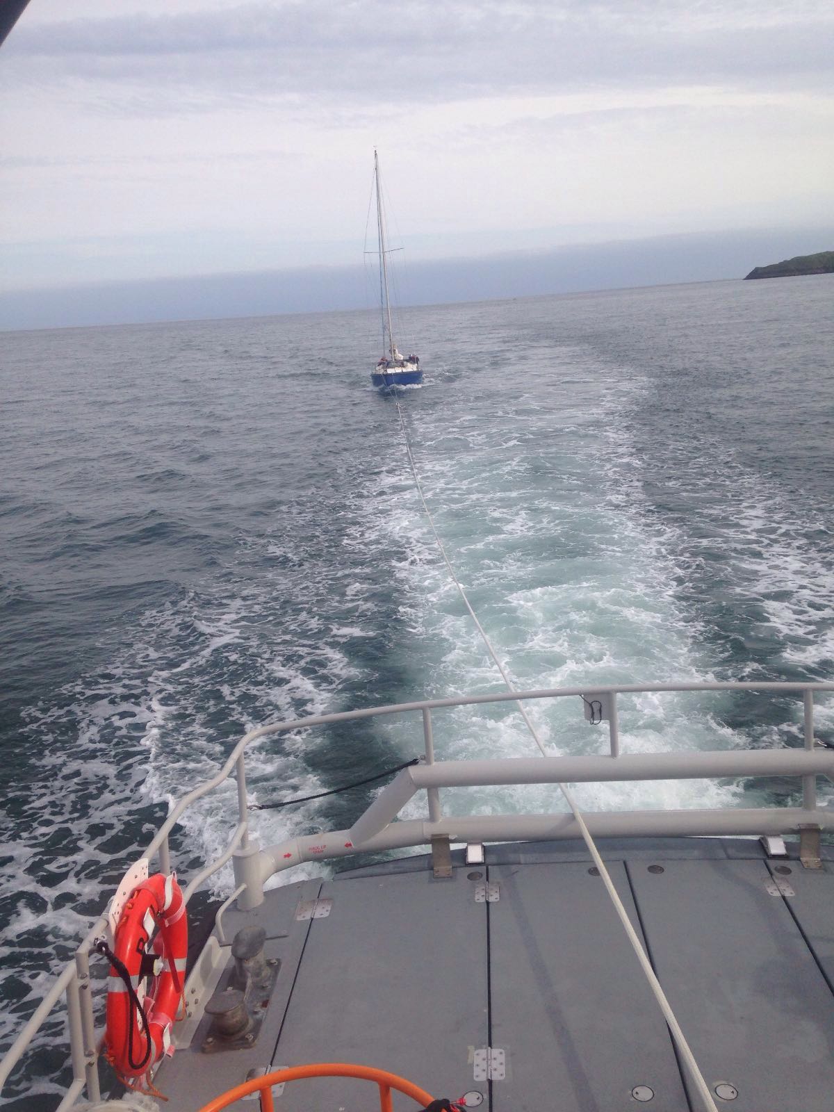 The yacht under tow towards Tenby.
