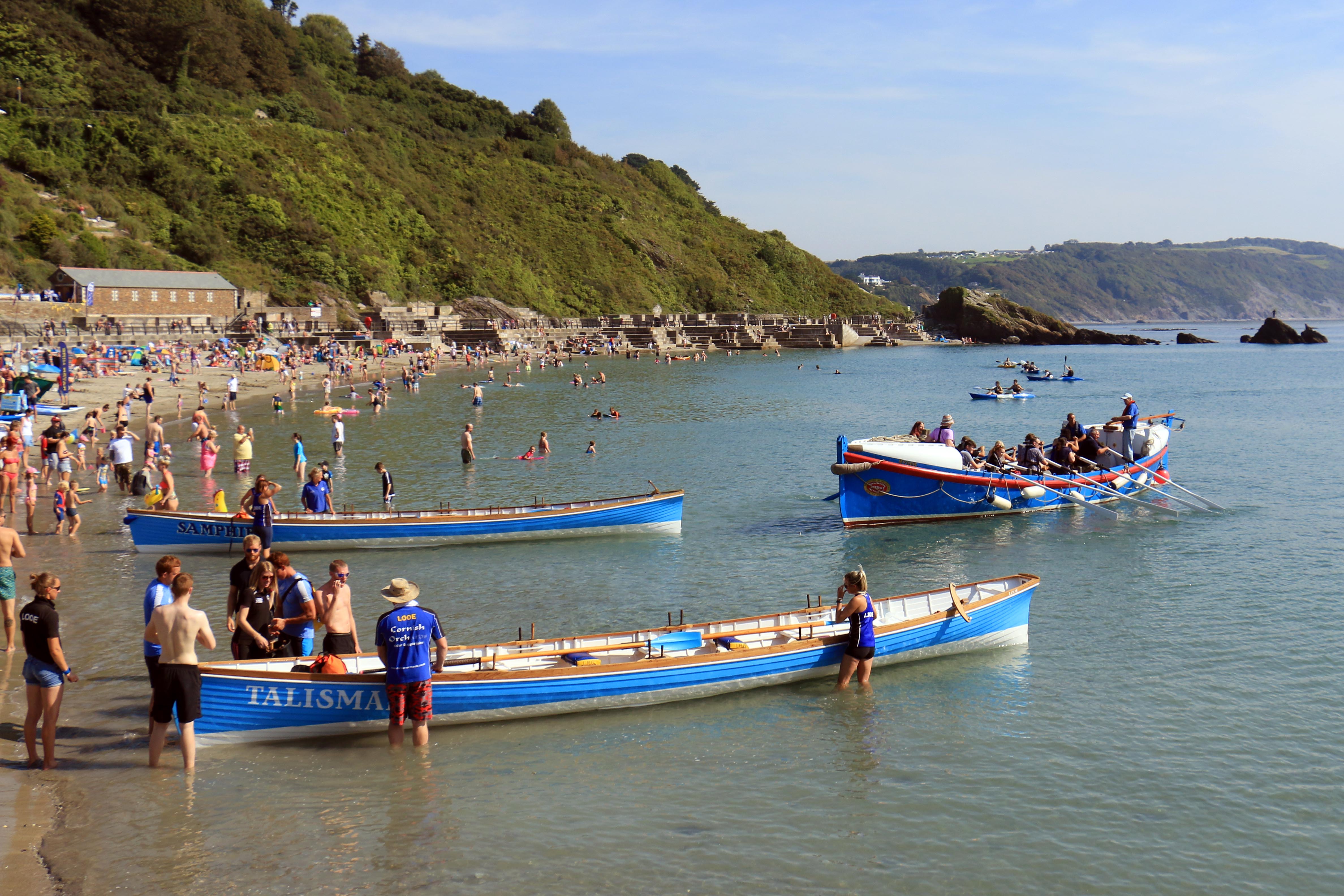Ex Looe Lifeboat Ryder off East Looe beach with Looe Rowing Club gigs