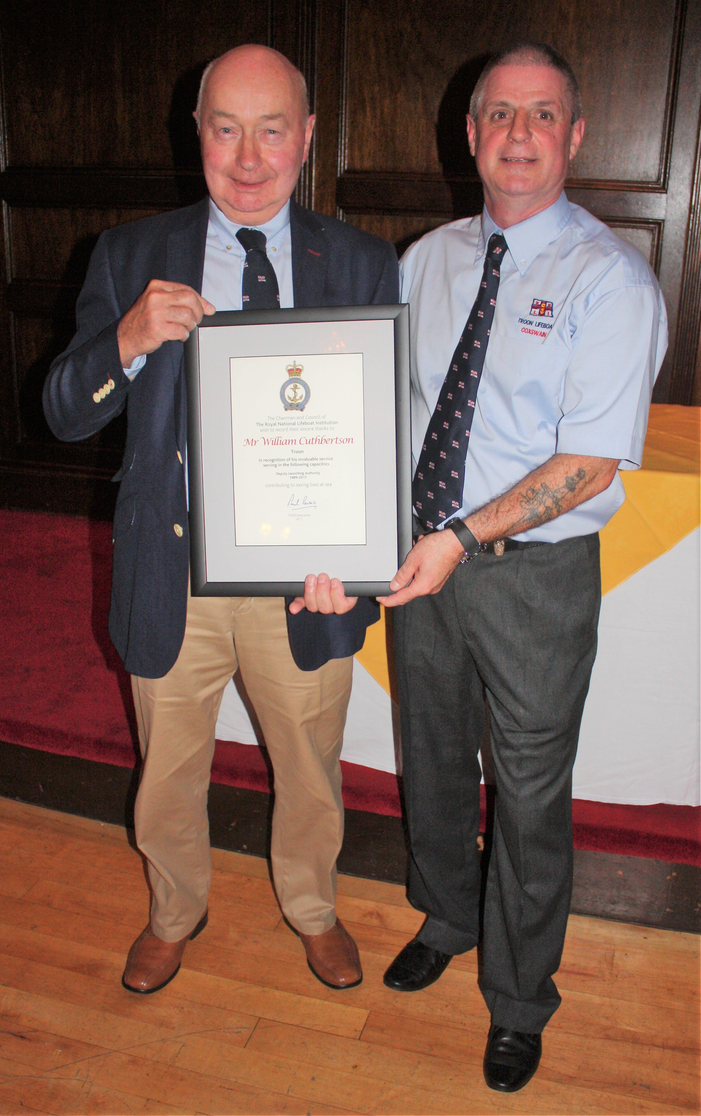 Recently retired Deputy Launching Authority William Cuthbertson receivies his certifcate from Coxswain Joe Millar