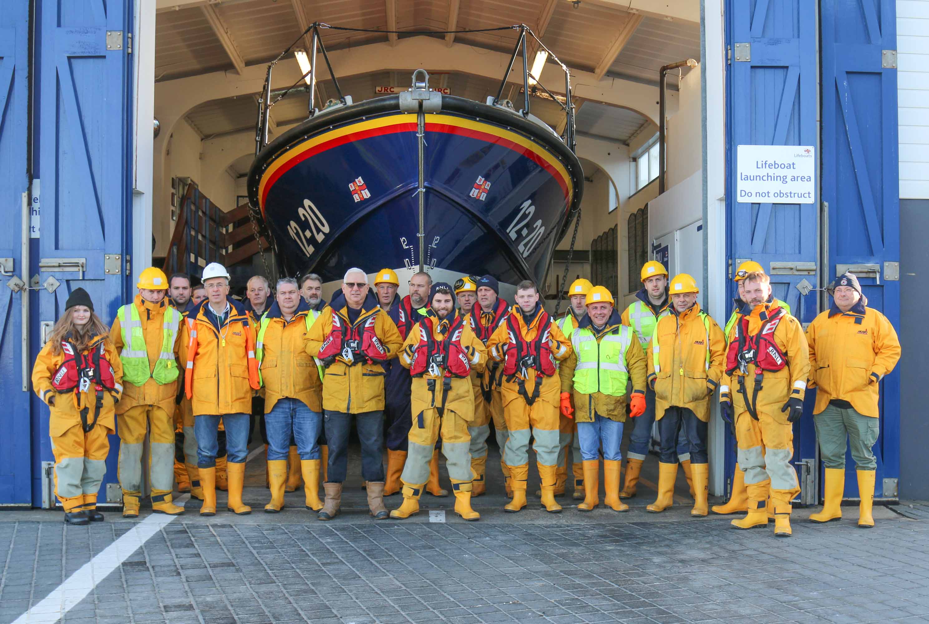 Alex (centre) with the lifeboat crew