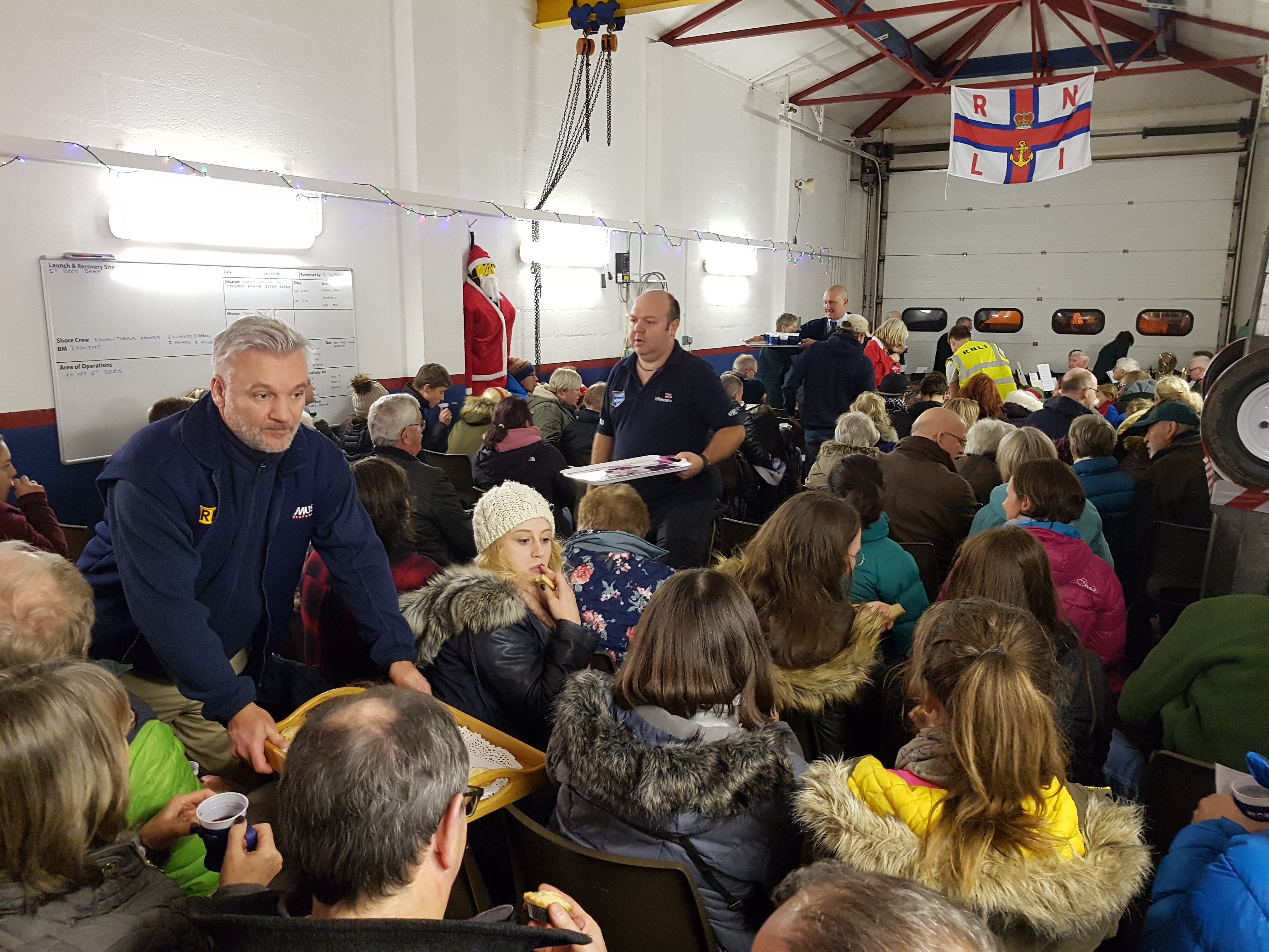 St Bees volunteer crew handing out mince pies and cakes during the interval