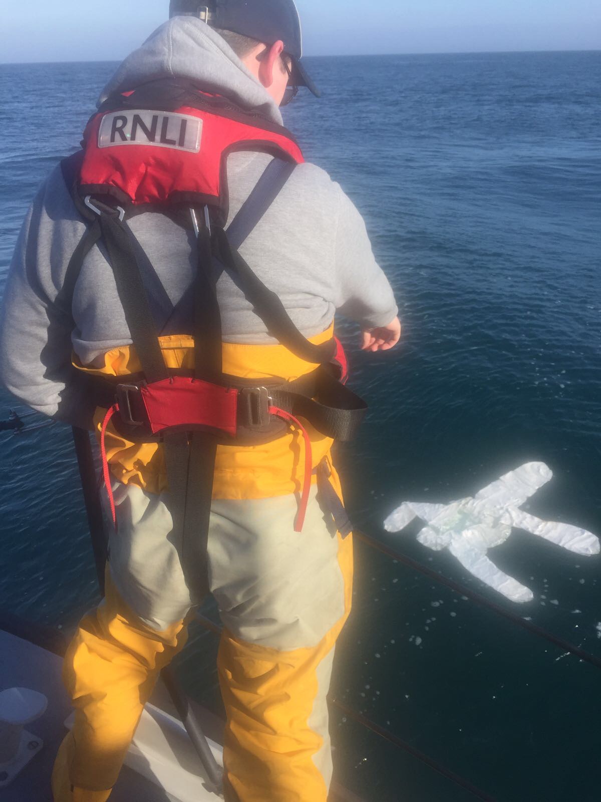 Crewman finds a white suit floating on the water