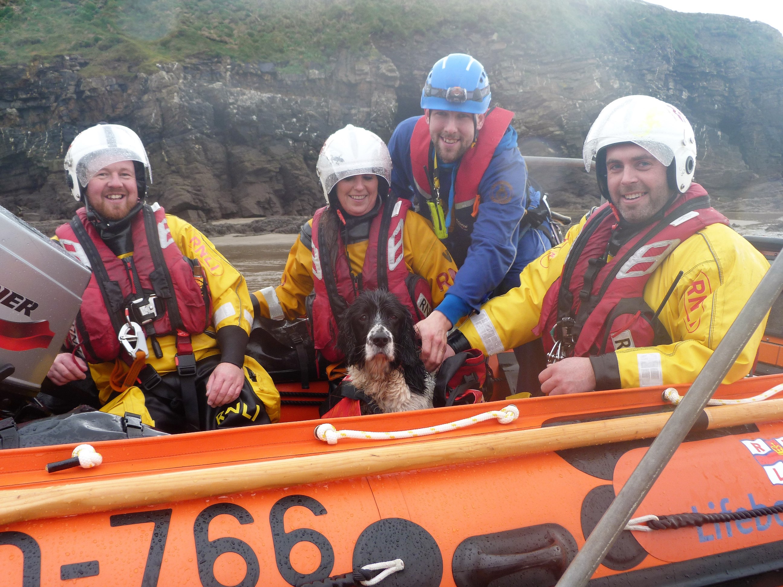 Rescued dog George with (from left RNLI lifeboat volunteers George Bevan, Vivienne Grey and Leigh Dunlop and Dan Church, from the Coastguard Rescue Team (back).