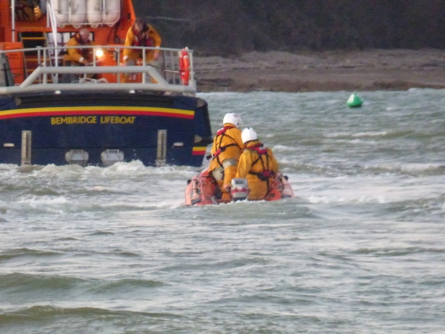 The volunteer crew on board the inshore lifeboat make their way back to the all weather lifeboat