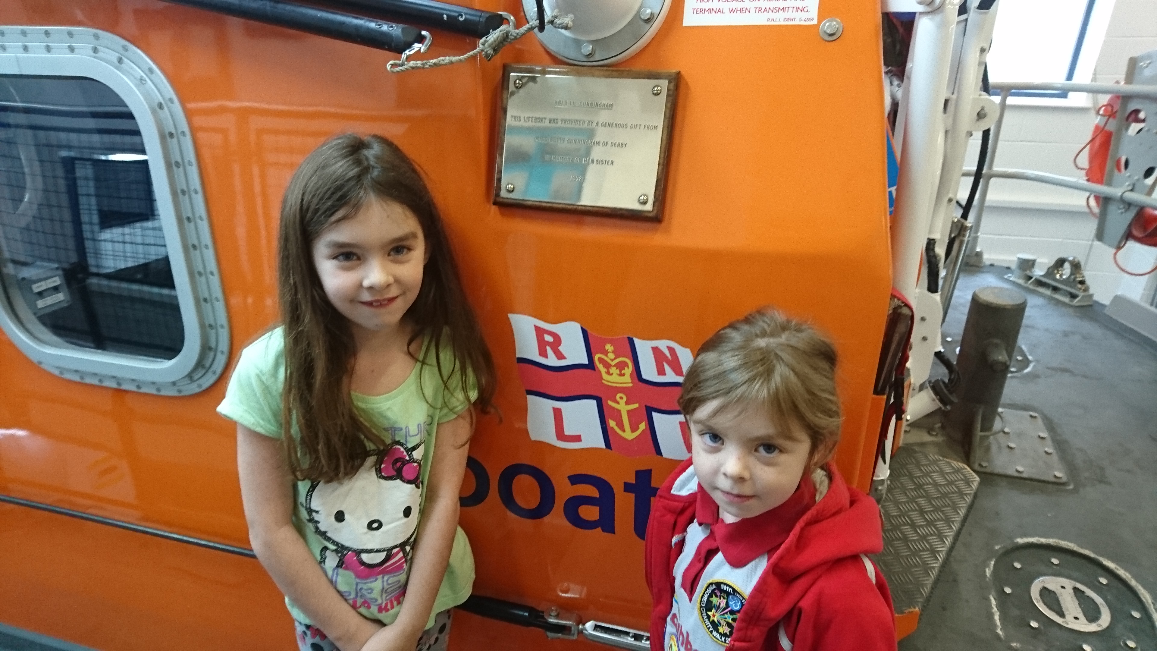Charisma (8) and Aurora (6) either side of the donor plaque on Rhyl Lifeboat