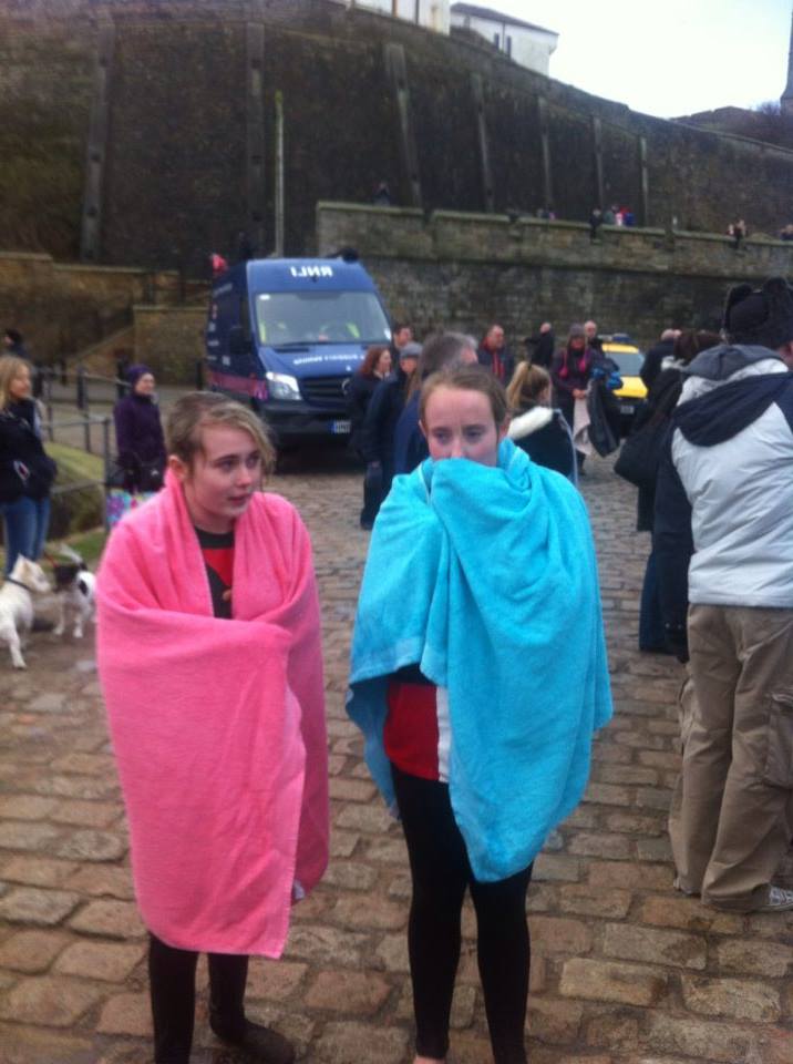 The two girls drying off and getting warmed up after their dip in the sea