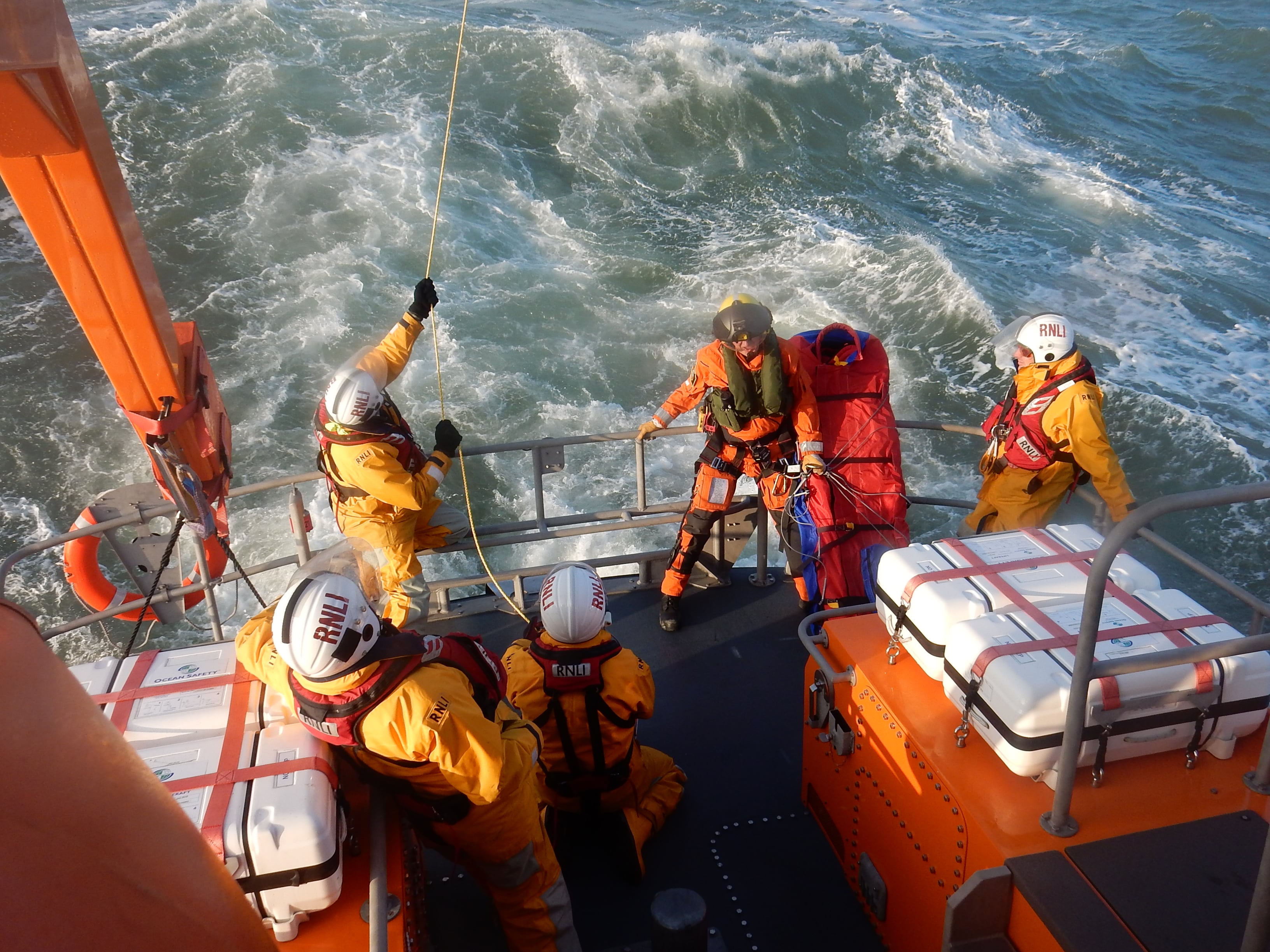 Winchman and stretcher on the deck of the RNLI's Yamouth lifeboat.