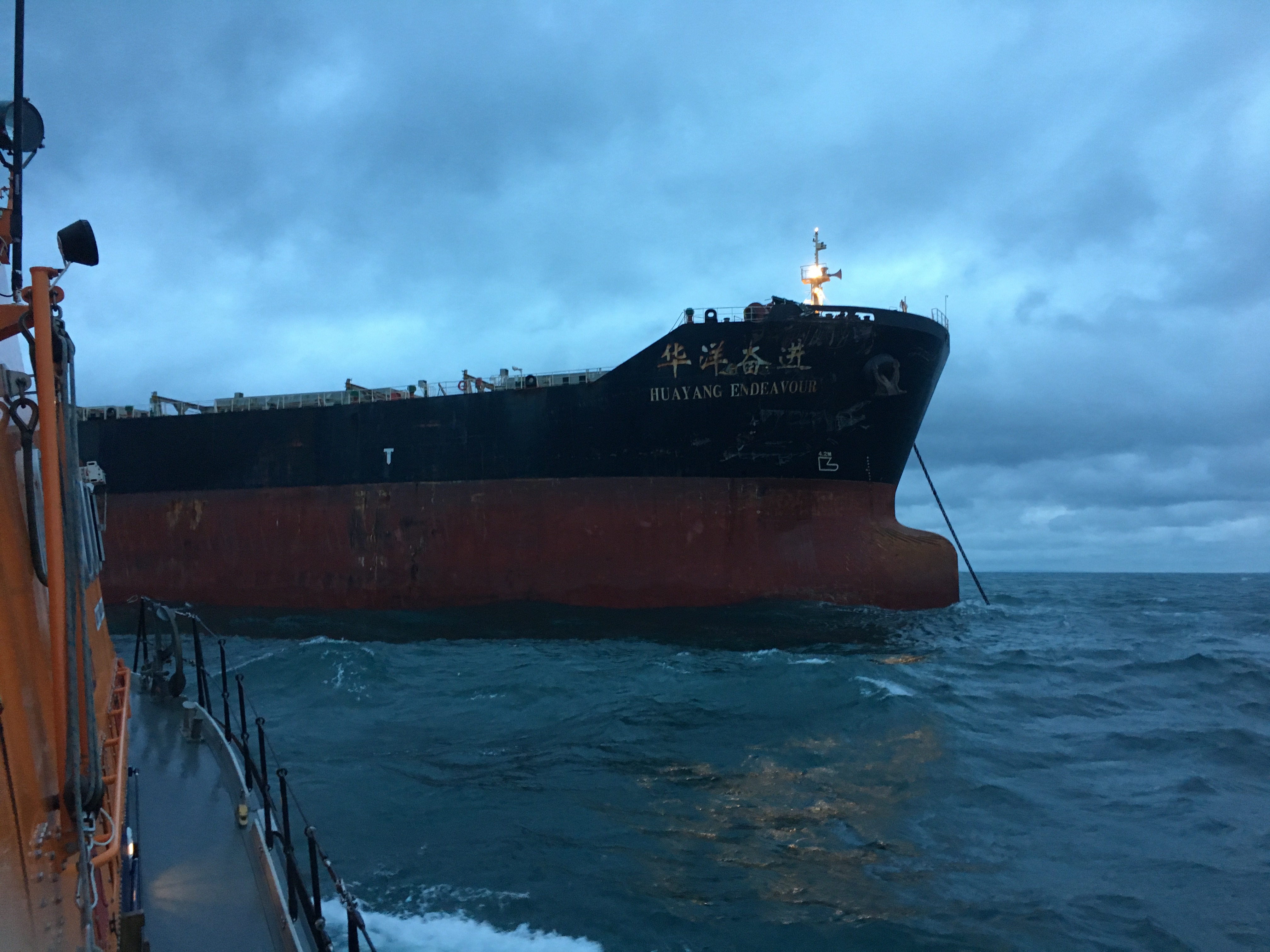 The Dover RNLI lifeboat stands off the Huayang Endeavour