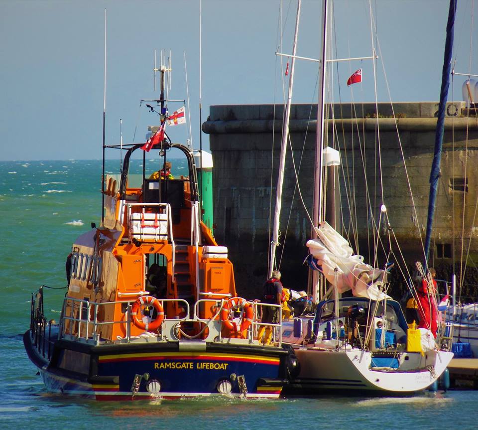 Lifeboat aiding rescued yacht onto berth in Ramsgate Harbour