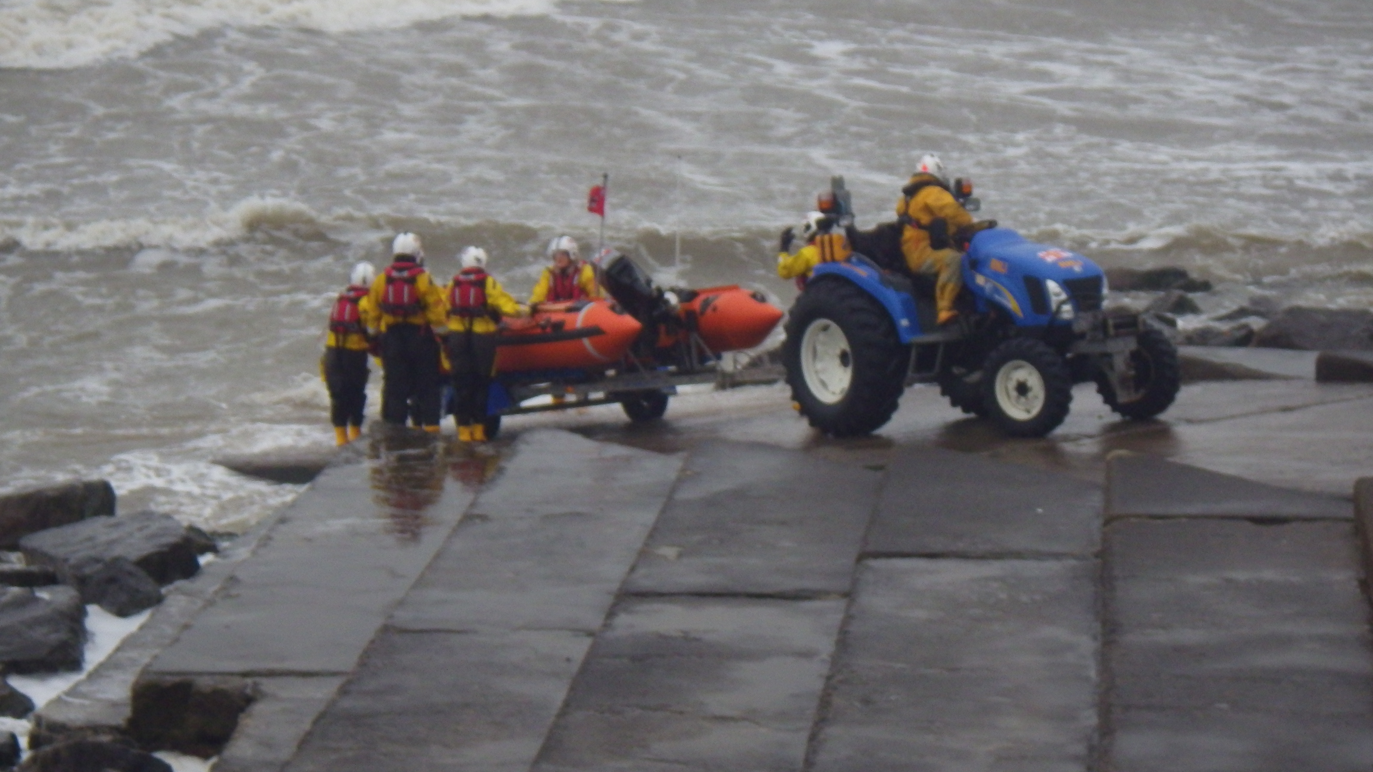 A wind swept sea breaking over the slipway during the launching
