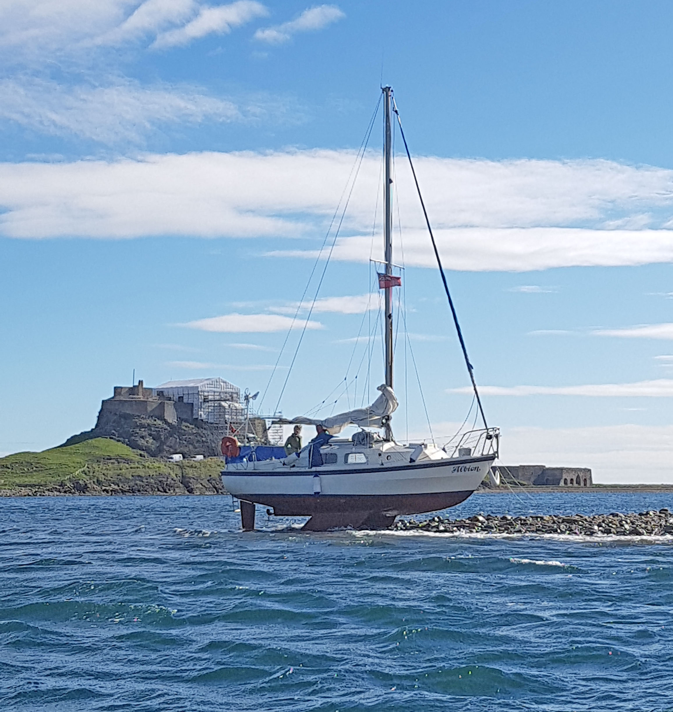 Yacht stranded below Lindisfarne Castle