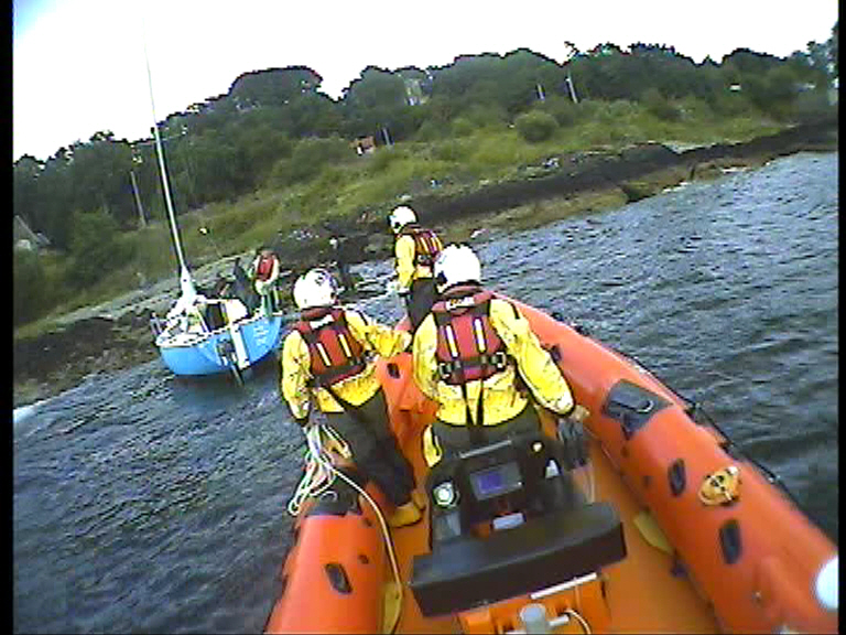 Helensburgh crew about to pull yacht off beach