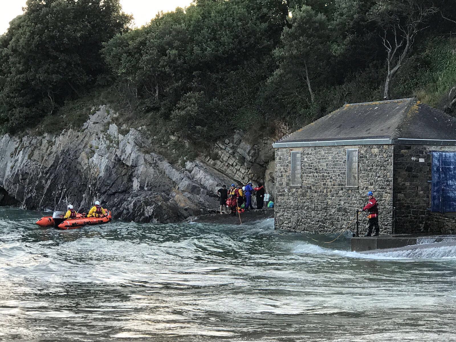 Lifeboat taking casualties from the ledge behind the pumping station at Caswell